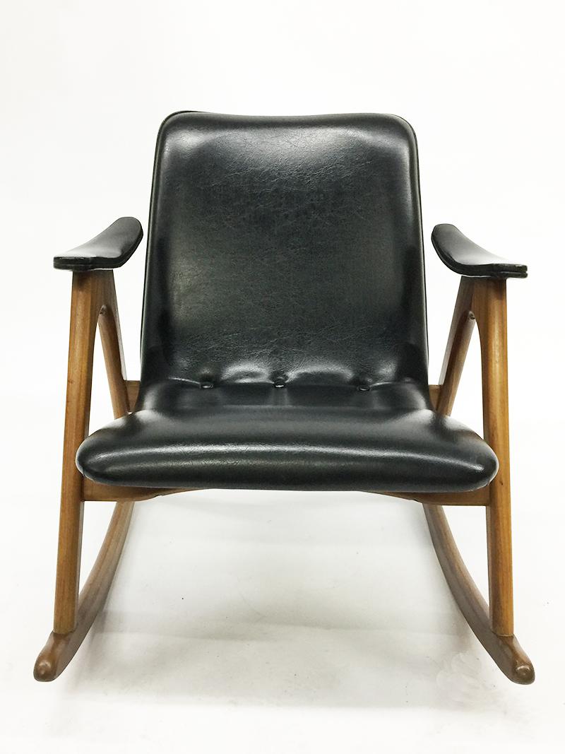 Rocking chair by Louis van Teeffelen for Webe, Netherlands, 1960s.

In Danish style upholstered in original black skai and teak frame

For details see the photos

The measurements are:

Total height is 69 cm
Seat height is 38 cm
70 cm wide