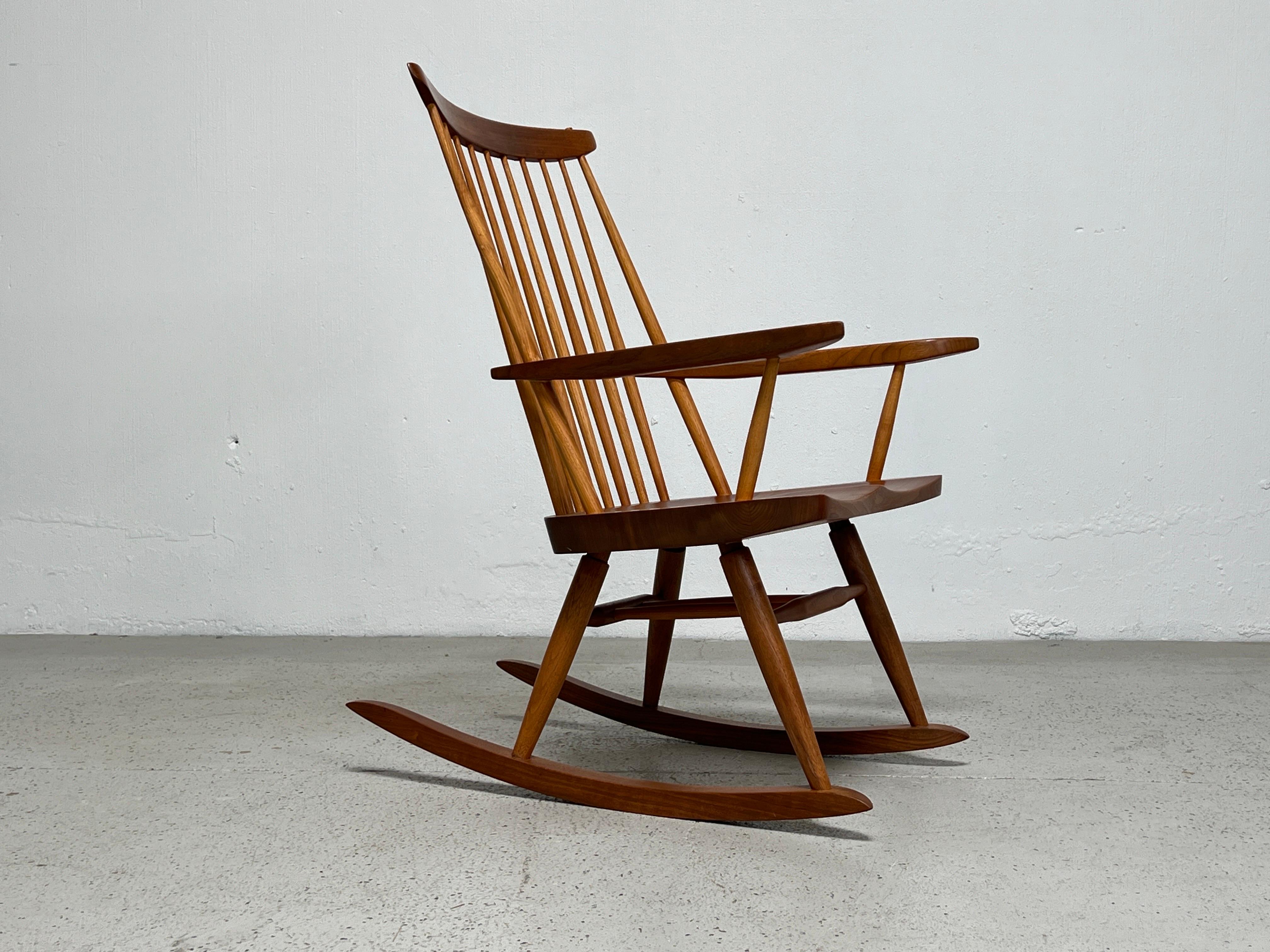 A rocking chair in black walnut made be the Nakashima studio and signed / dated by Mira Nakashima, 1993.