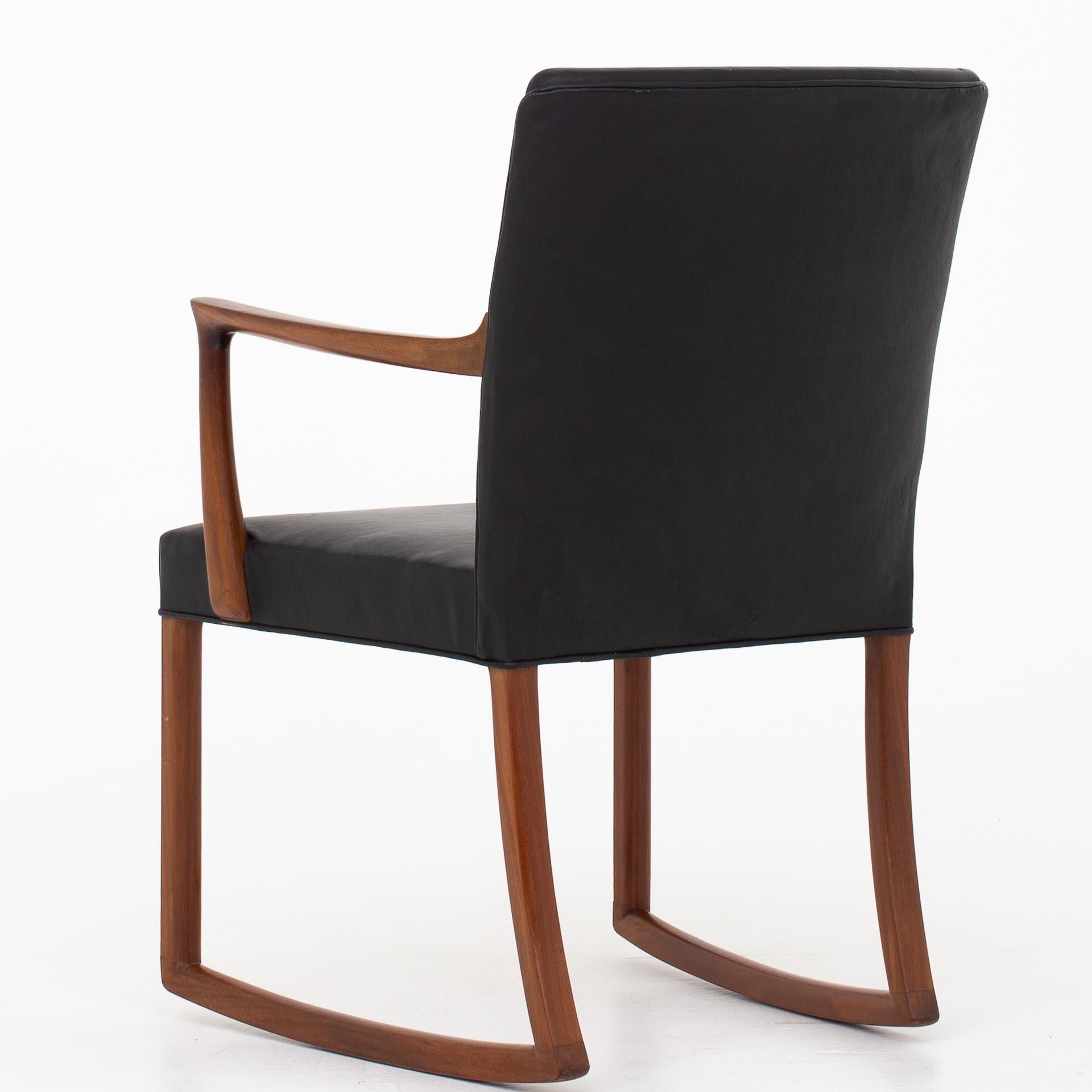 Rocking chair in mahogany and patinated black leather. Maker A. J. Iversen.