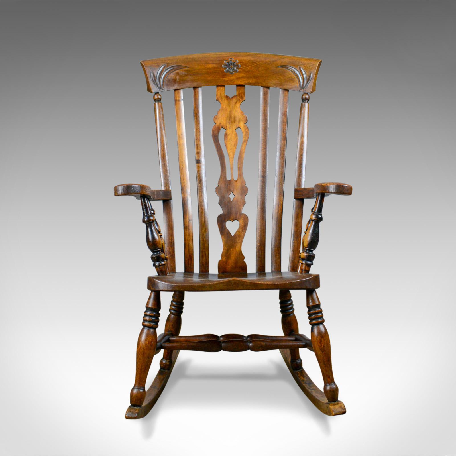 This is an antique rocking chair. An Edwardian, country kitchen, Windsor, lath back, elbow chair in beech and elm, dating to the early 20th century, circa 1910.

Super chair in fine order throughout
Classic, lath back flanking pierced splat
Good