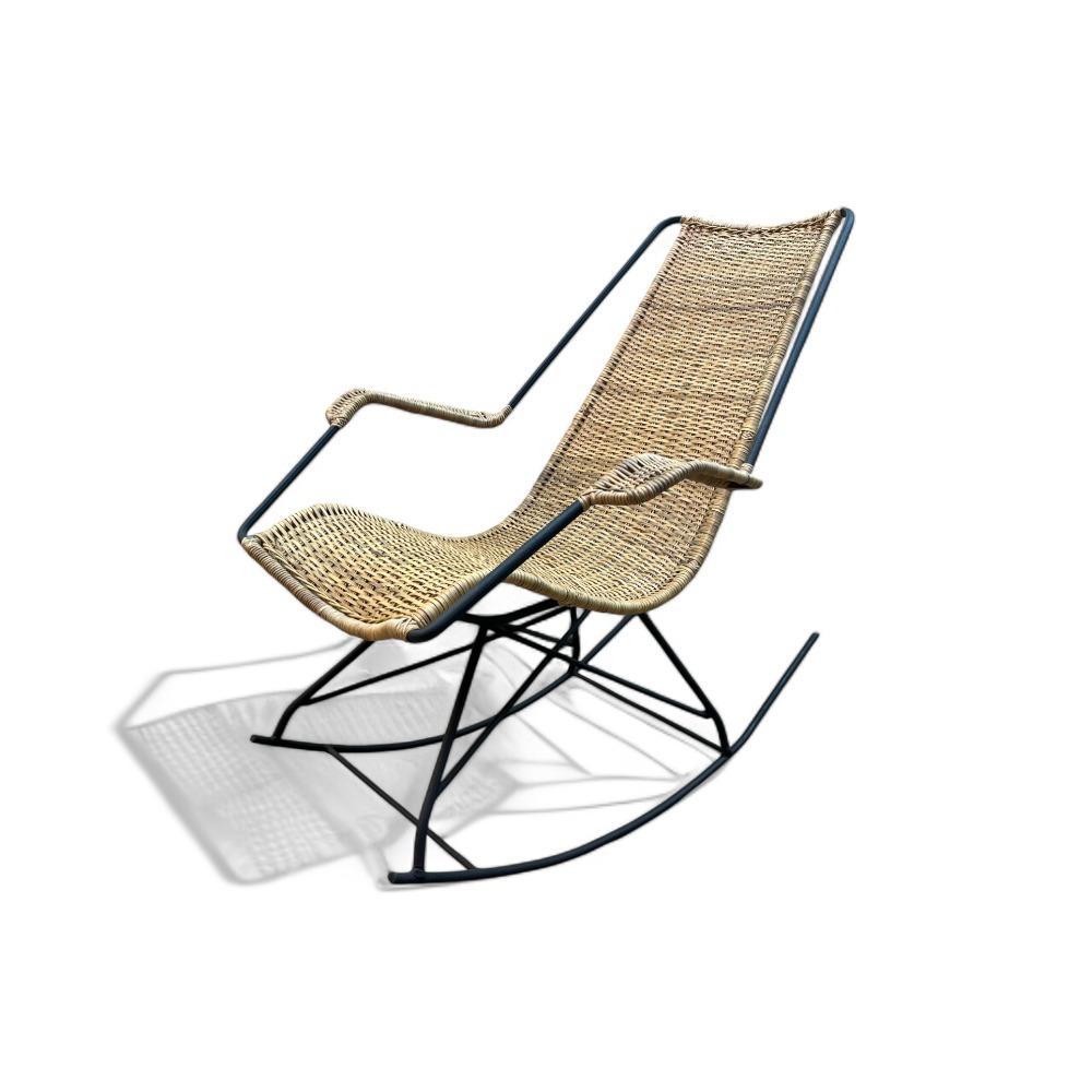 Rocking chair made in metal and wicker designed by Carlo Hauner in the 1950’s. The sculptural piece has been completely restored. The wicker is new and the metal has been painted in black. Equally comfortable as beautiful, a piece like this will be