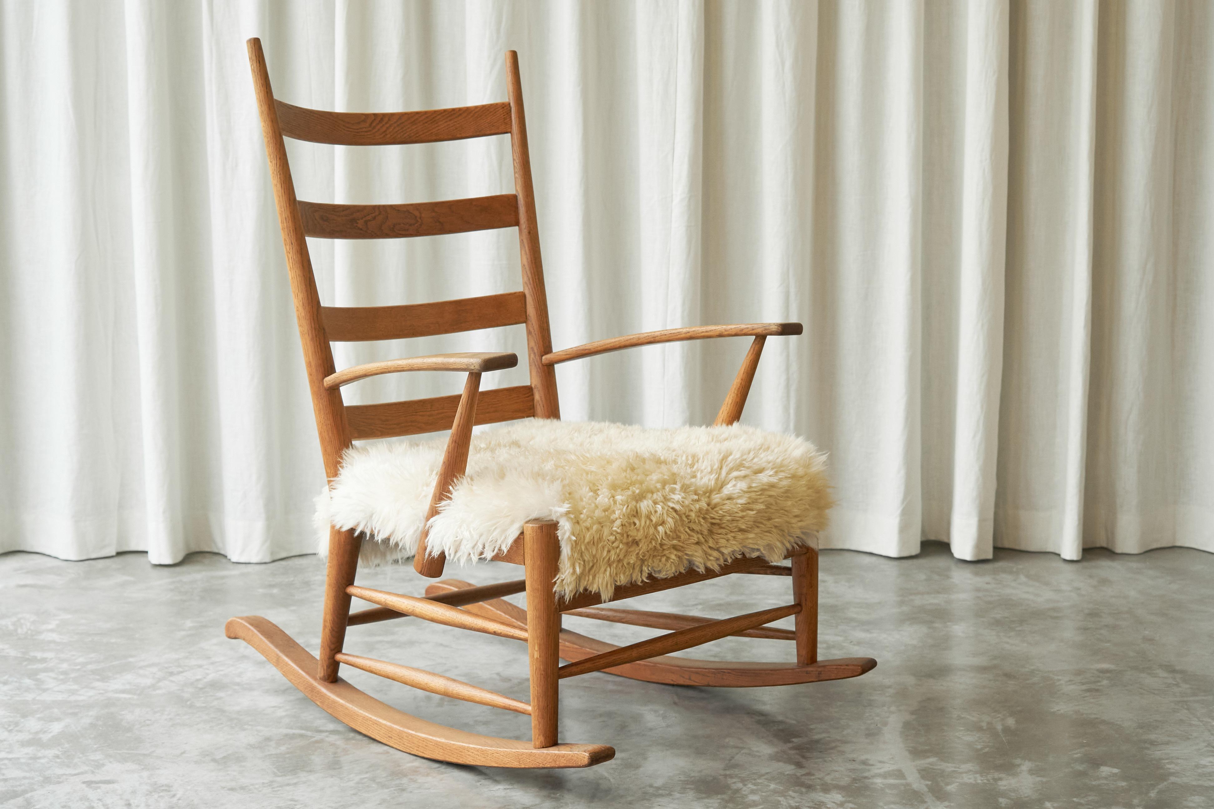 Rocking Chair in Solid Oak and Sheepskin, France 1960s.

Sit down and relax…. Enjoy your book, a warm cup of tea or a good glass of wine. Coming home after a long day will never be the same, thanks to this wonderful 1960s rocking chair. It was made
