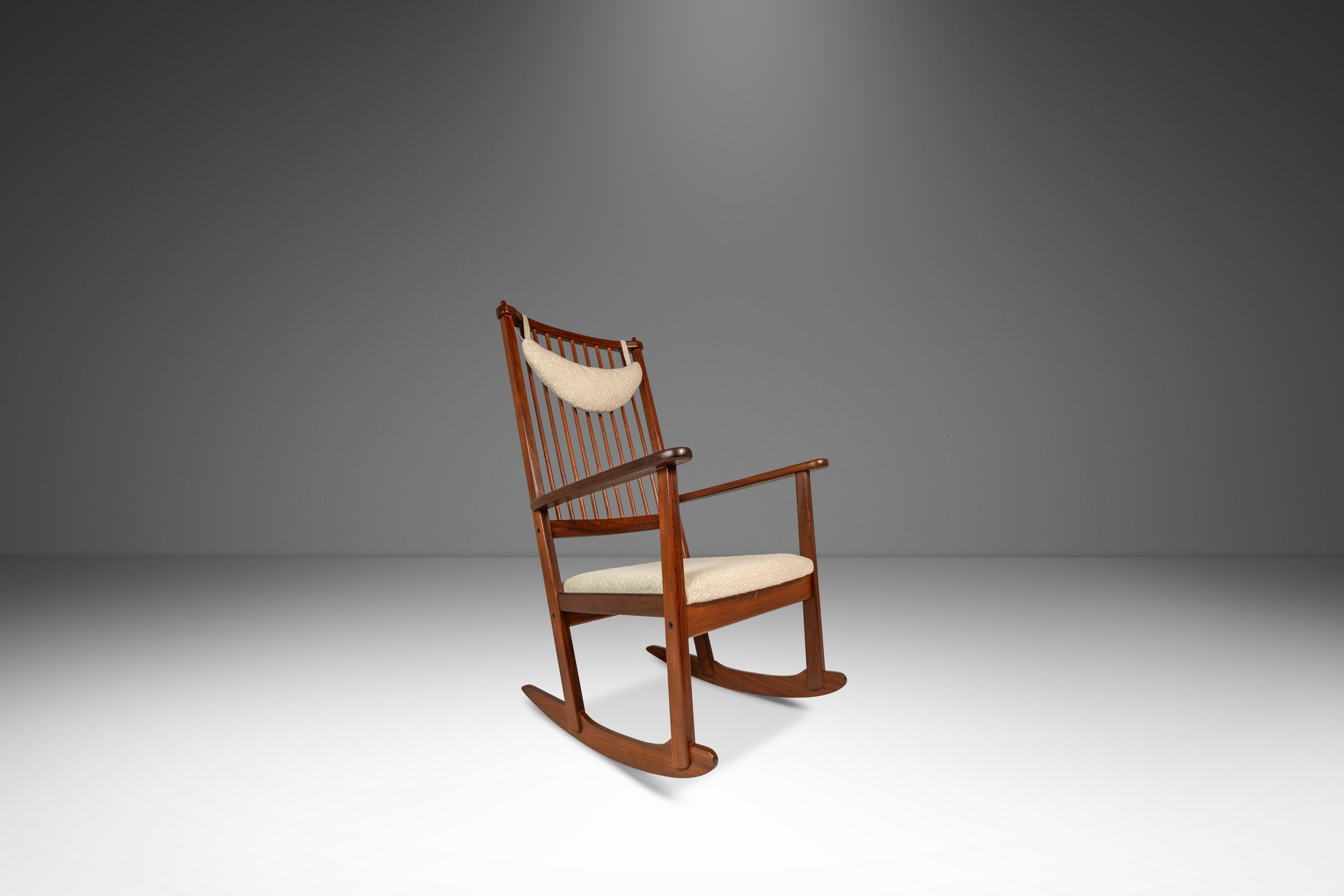 This elegant Mid-Century Modern rocking chair, designed by Yngve Ekström for Swedese in the 1960s, exemplifies Scandinavian design with its solid teak frame and newly custom upholstered Cloud Light Gray nubby Bouclé fabric. The rich, honey-toned