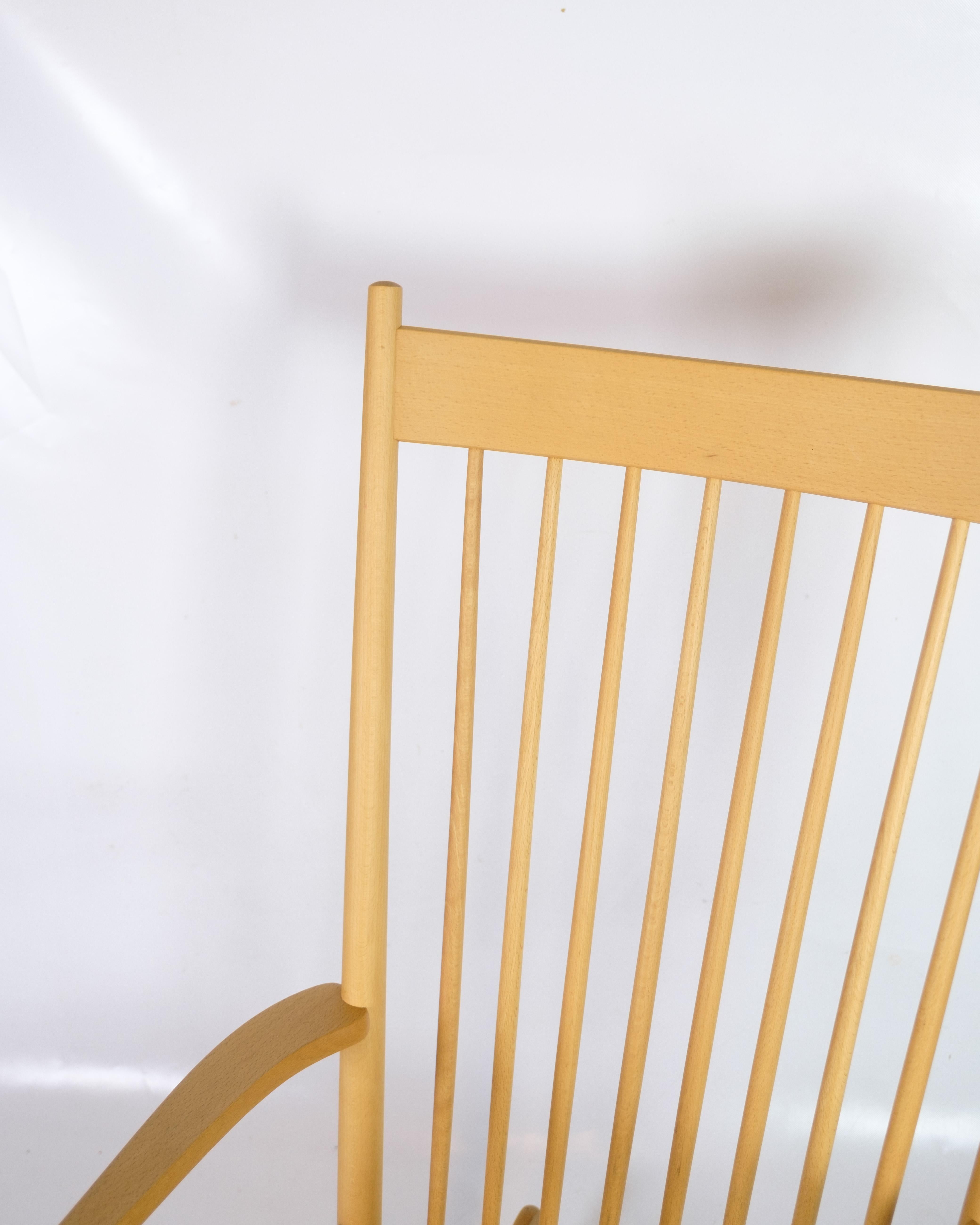 Sedia a dondolo, modello J16, disegnata da Hans J. Wegner per FDB Møbler. La sedia è realizzata in legno di faggio e ha un sedile in vimini, intrecciato a mano per garantire resistenza e comfort. Con la sua forma semplice e funzionale, il J16 è