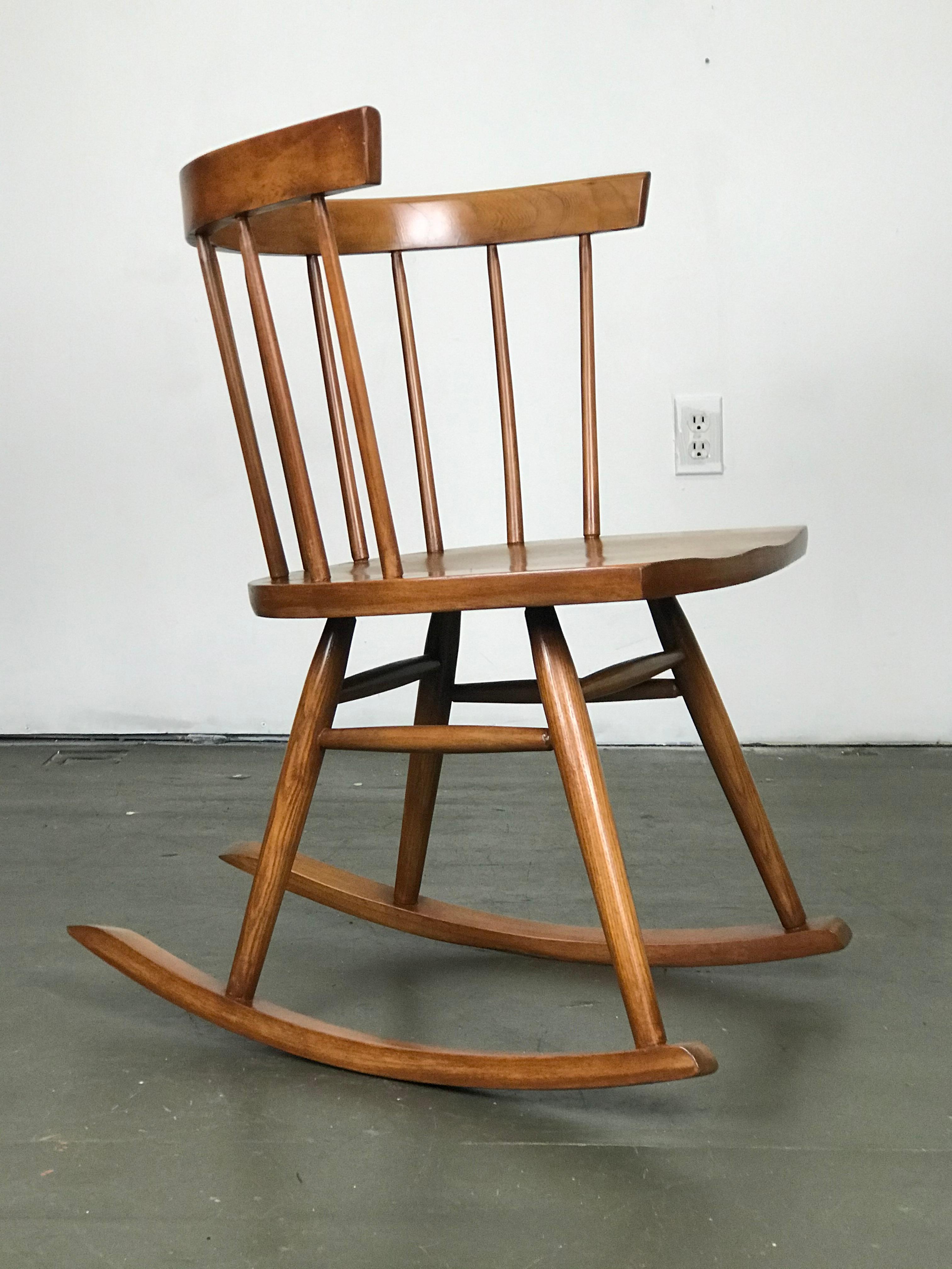 Minimalist Windsor George Nakashima style rocker by Lucian Ercolani for Ercol Furniture of England, circa 1950s. This has been recently refinished yet used since refinishing, and shows some very minor wear. Studio lighting brightens the color. It's
