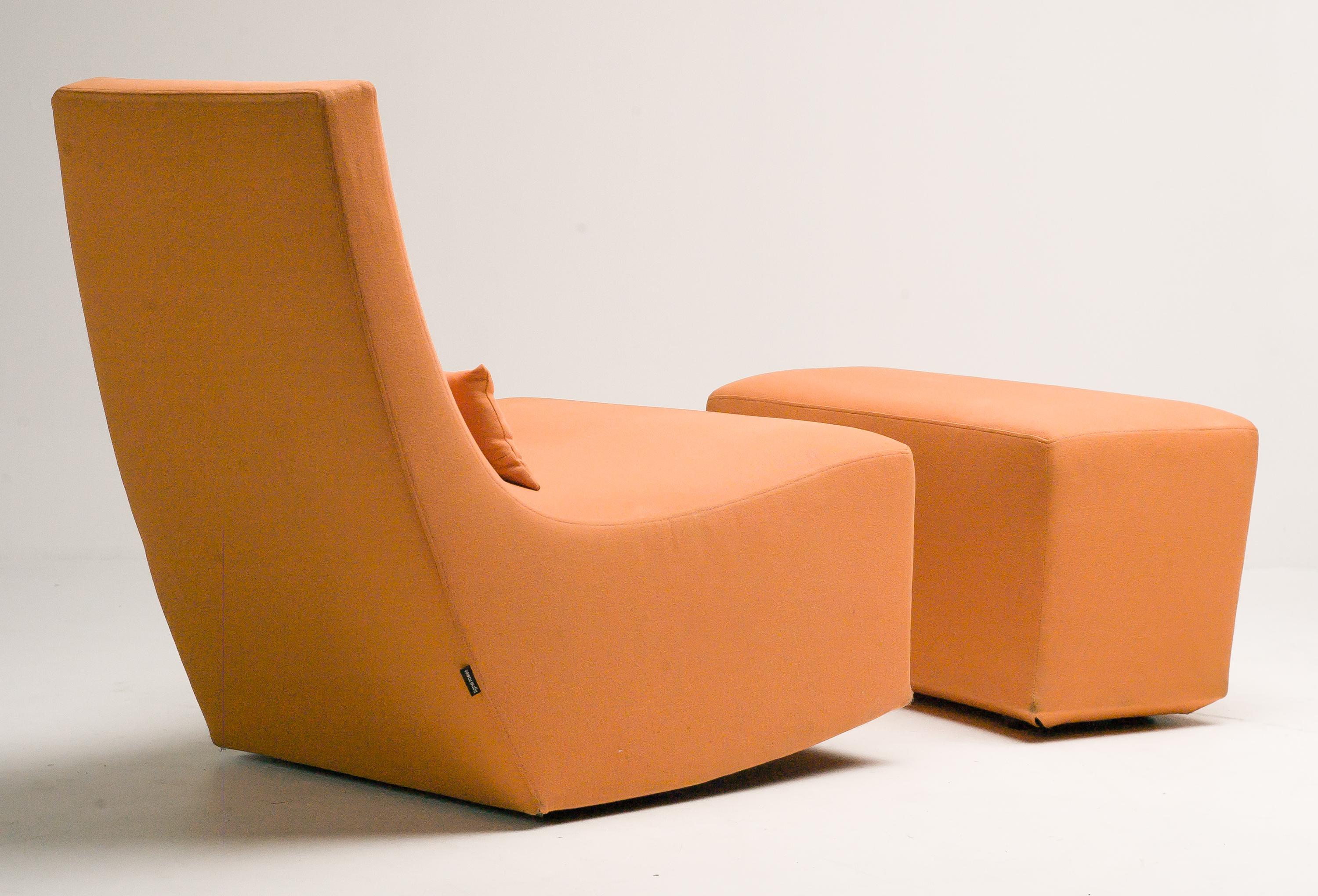 Ligne Roset rocking lounge chair and ottoman.
The chair has a subtle rocking motion which can be adjusted.
Original orange fabric with label.
The set has a zippered cover upholstery, replacement is very easy when desired.
   