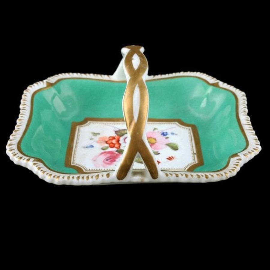 An early 19th century Rockingham China miniature basket.

The basket is shaped with a gilt decorated gadrooned edge and has an intertwined strap handle.

The interior is green with a central panel of colourful hand painted flowers.

The basket
