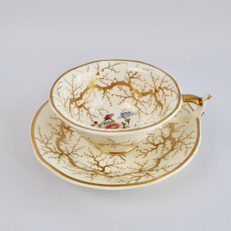 On offer is a teacup and saucer made by Rockingham in about 1832. The set is decorated with a gilt seaweed pattern and beautiful little flower posies.

We have an entire tea service for 4 available, as well as various other cups and saucers,