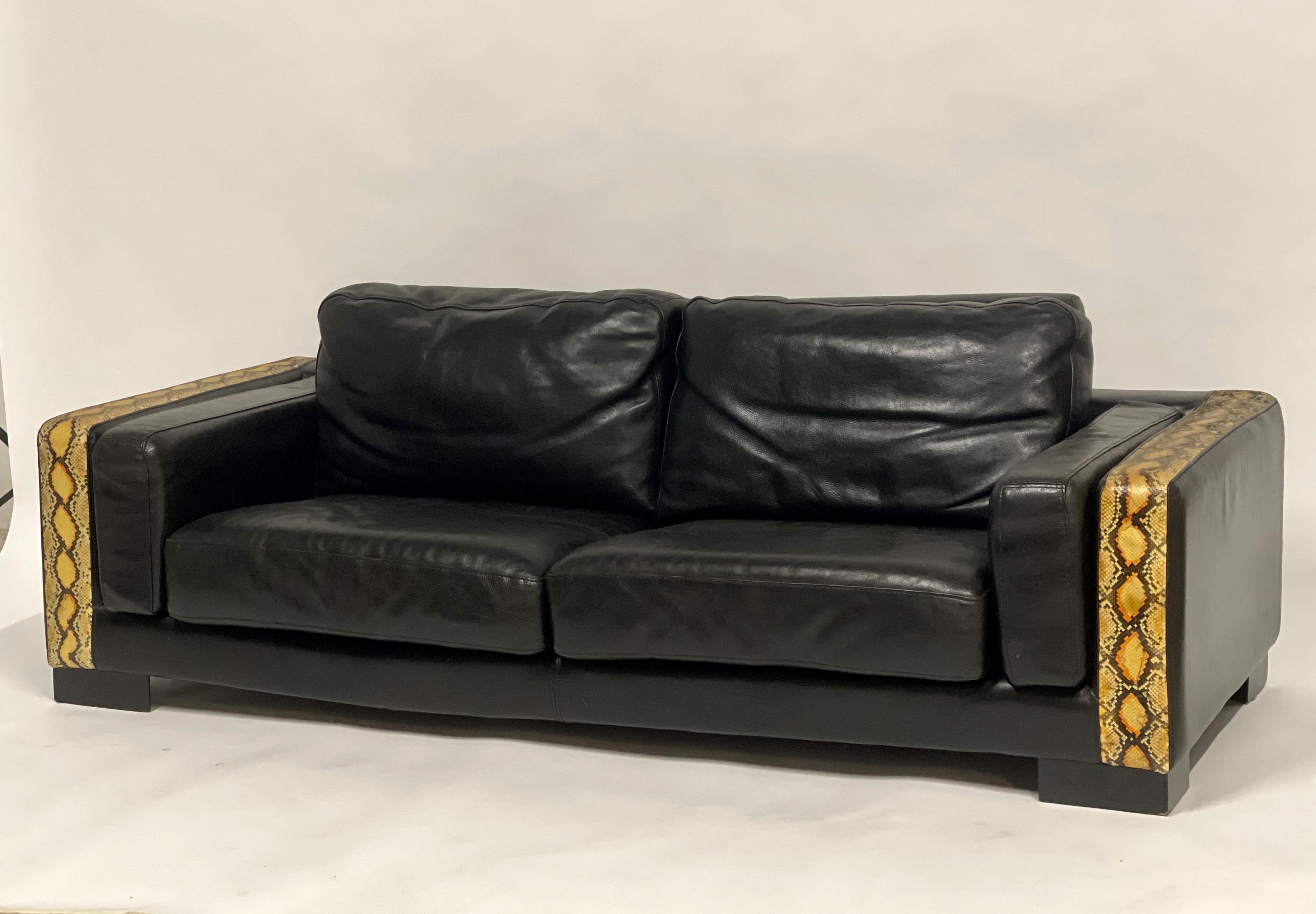 Large scale sofa with butter soft yet durable thick black leather- like a moto jacket. Trim is python embossed leather. This piece is so unique and absolutely stunning in person and so comfortable. 

  