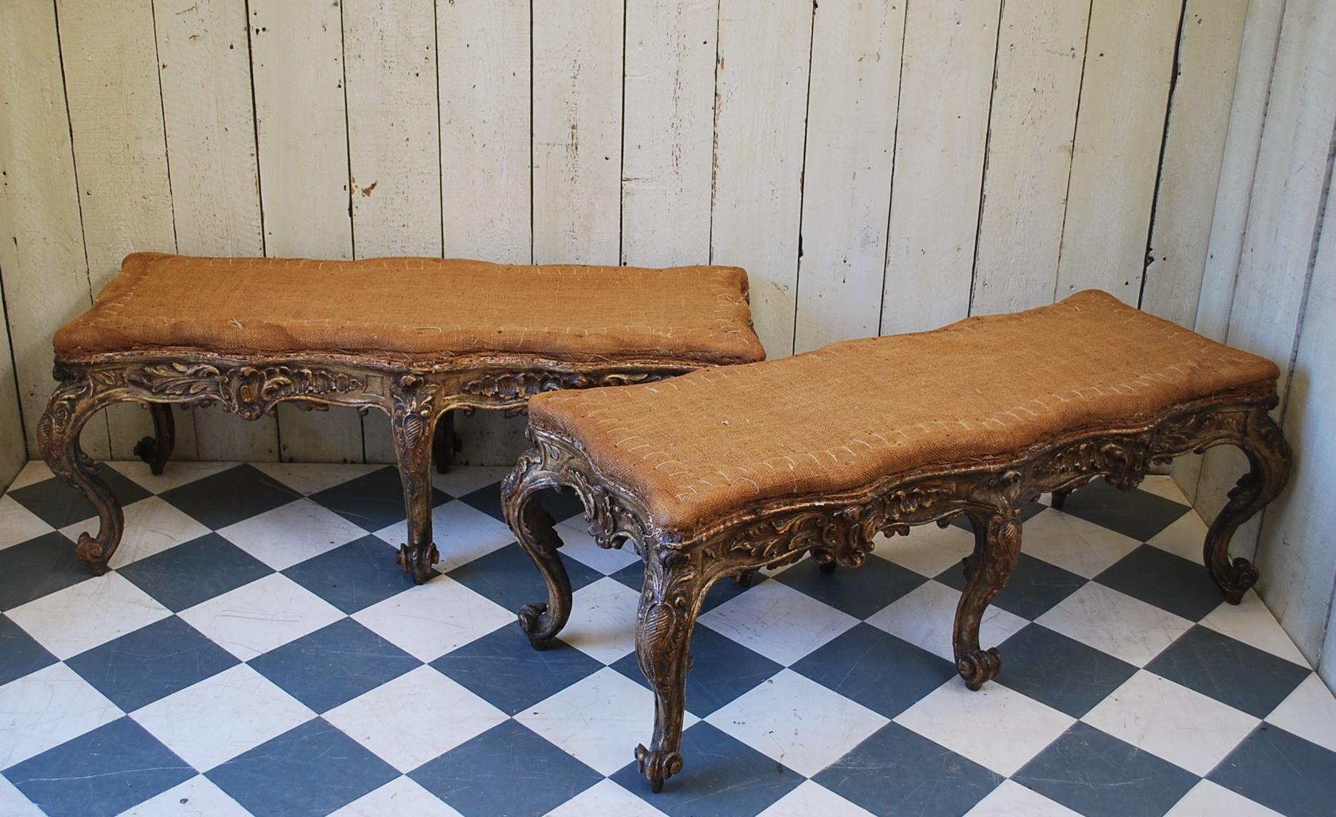 A superb pair of rare Italian carved giltwood Rococo stools, standing on cabriole legs terminating on scroll feet. Beautifully embellished in deep carving on all sides, with serpentine shaped overstuffed upholstered seats ready for upholstery. A