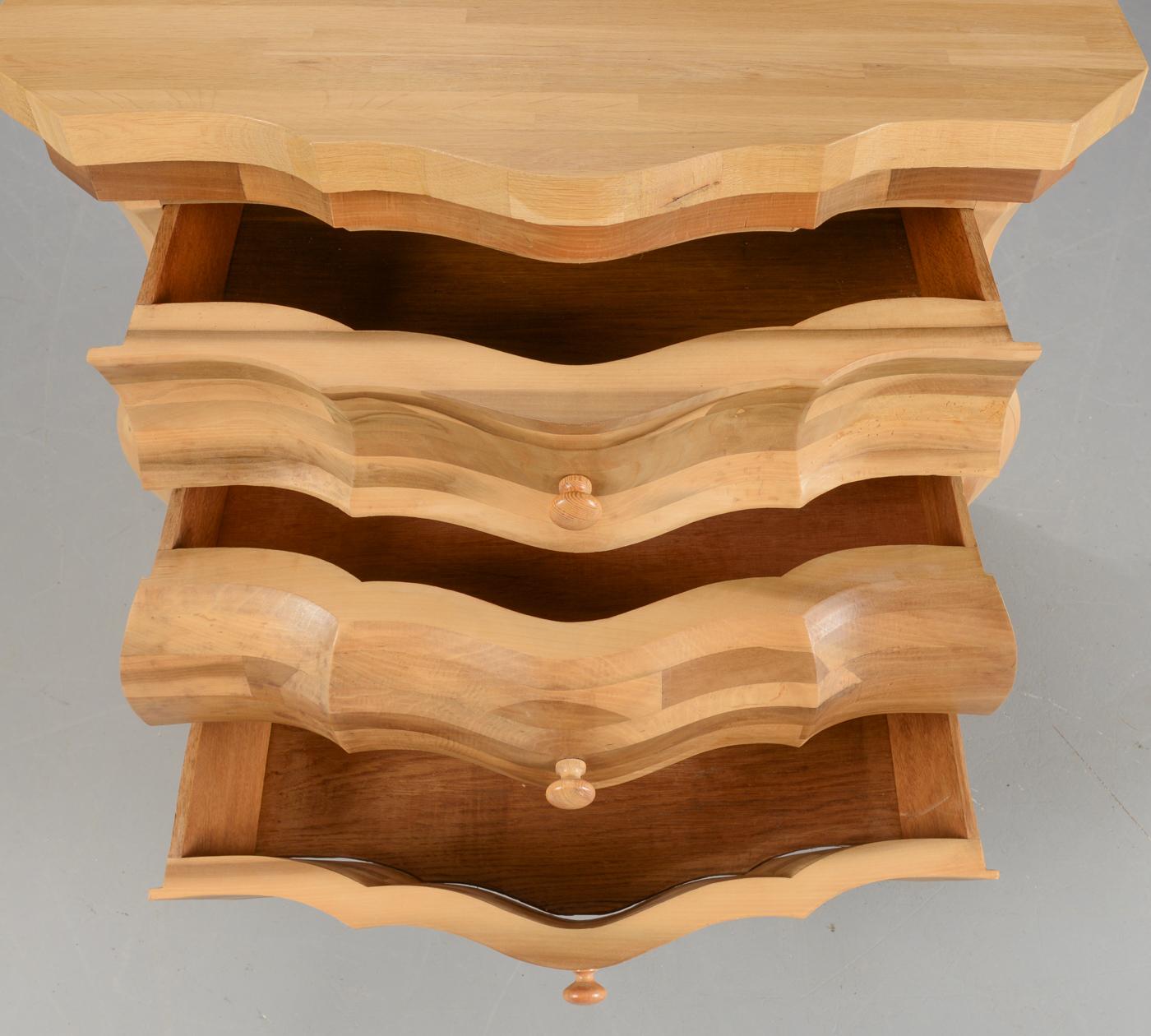 Unusual Danish modern diminutive chest of drawers in the Rococo style, bombe shaped, in light oak. The front of the chest is oak marquetry.