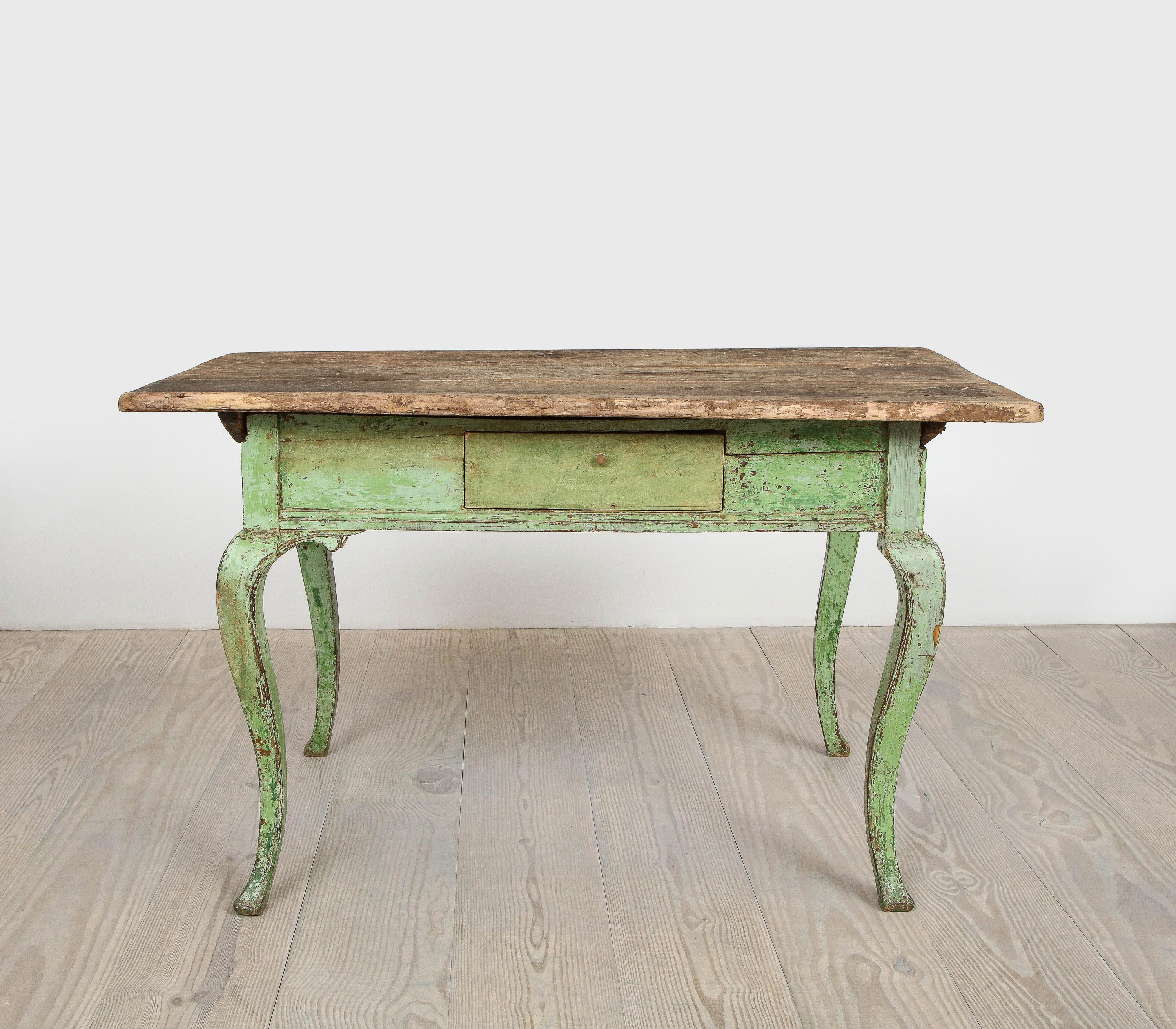 Fantastic Rococo 18th century writing table with single drawer with accentuated cabriole legs, origin: Sweden, circa 1760 with all original green color.

The purity of the design lacking any adornments along with the pared down elements of this