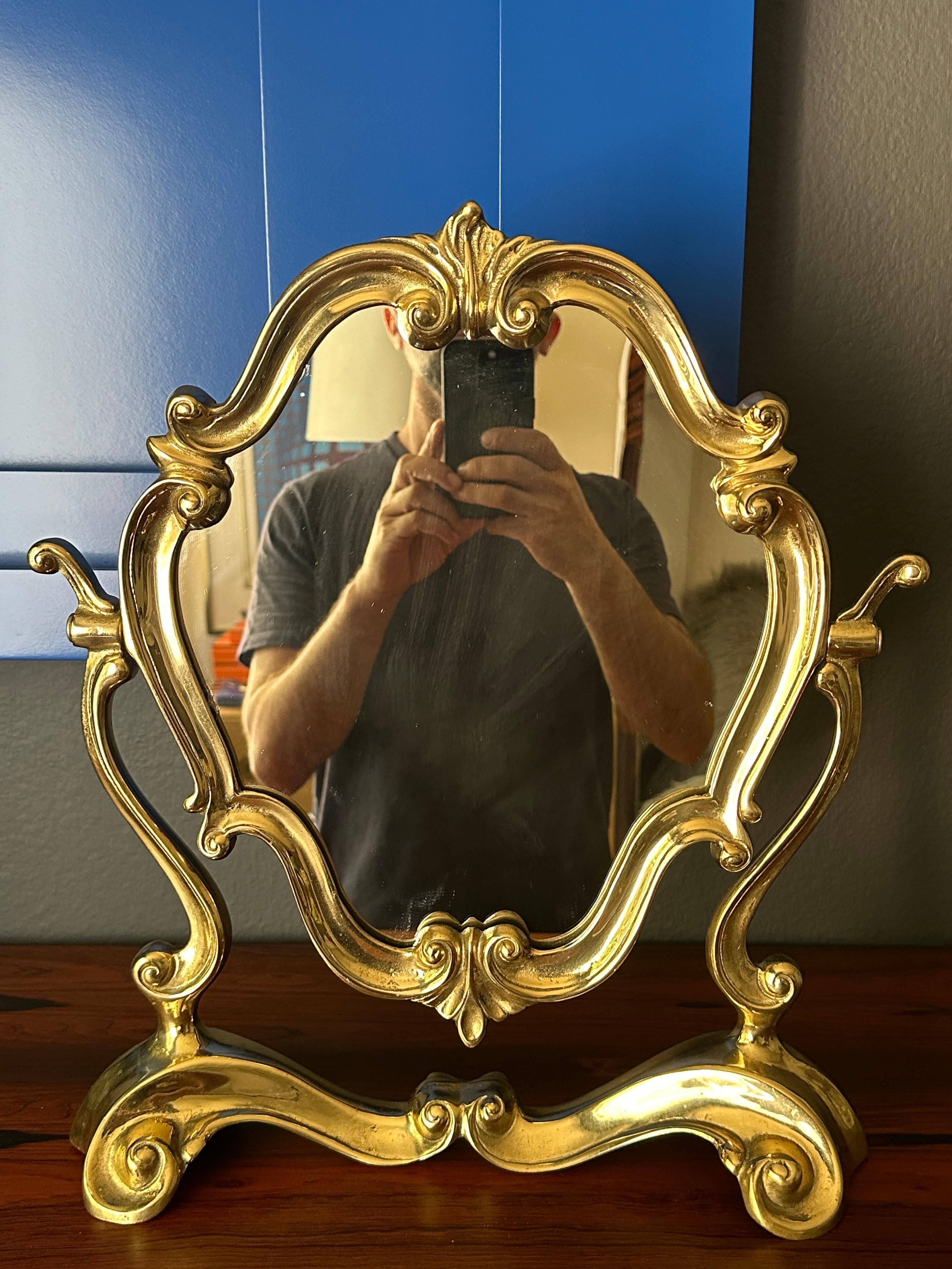 Italian Rococo heavy brass tilting vanity mirror.