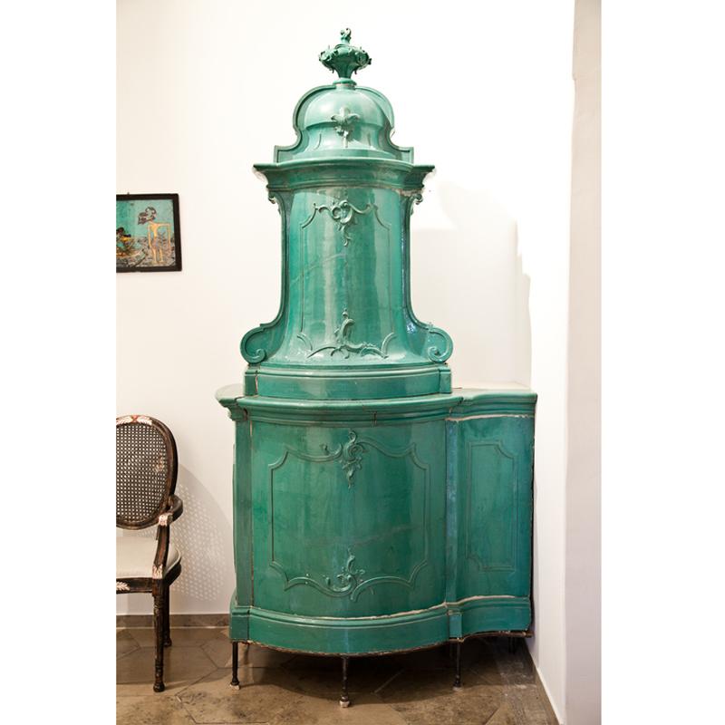 Beautiful ceramic stove with green enamel tiles from the home of a royal family near Würzburg, Southern Germany. The stove is a corner stove, but can be redesigned under use of a modern glass door to be a standalone stove. The stove has its original