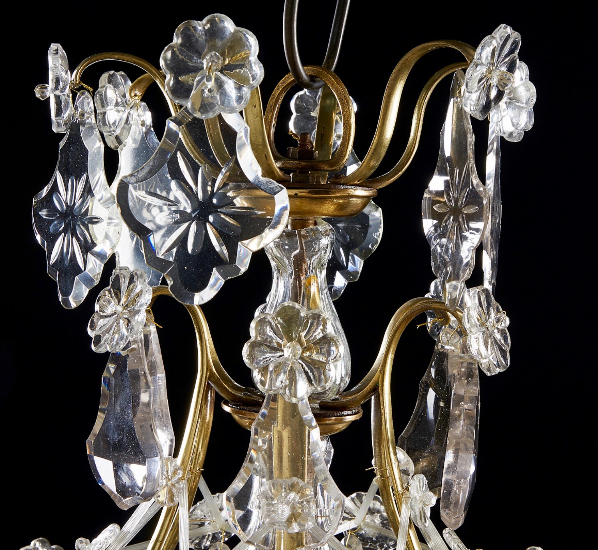 A Swedish Rococo chandelier made in the second half of the 18th century. Unusually small. The chandelier has a brass skeleton with crystals that are shaped like leafs, flowers and a lot more. All handcut and very good condition.