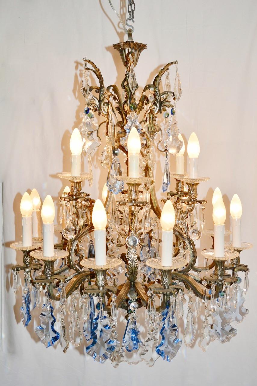 Italian Rococo style bronze chandelier with blue and clear crystals / Made in Italy circa 1930's
18 lights / E14 type / max 40W each
Height: 39.5 inches plus chain and canopy / Diameter: 29 inches 
1 in stock in Italy currently ON SALE for