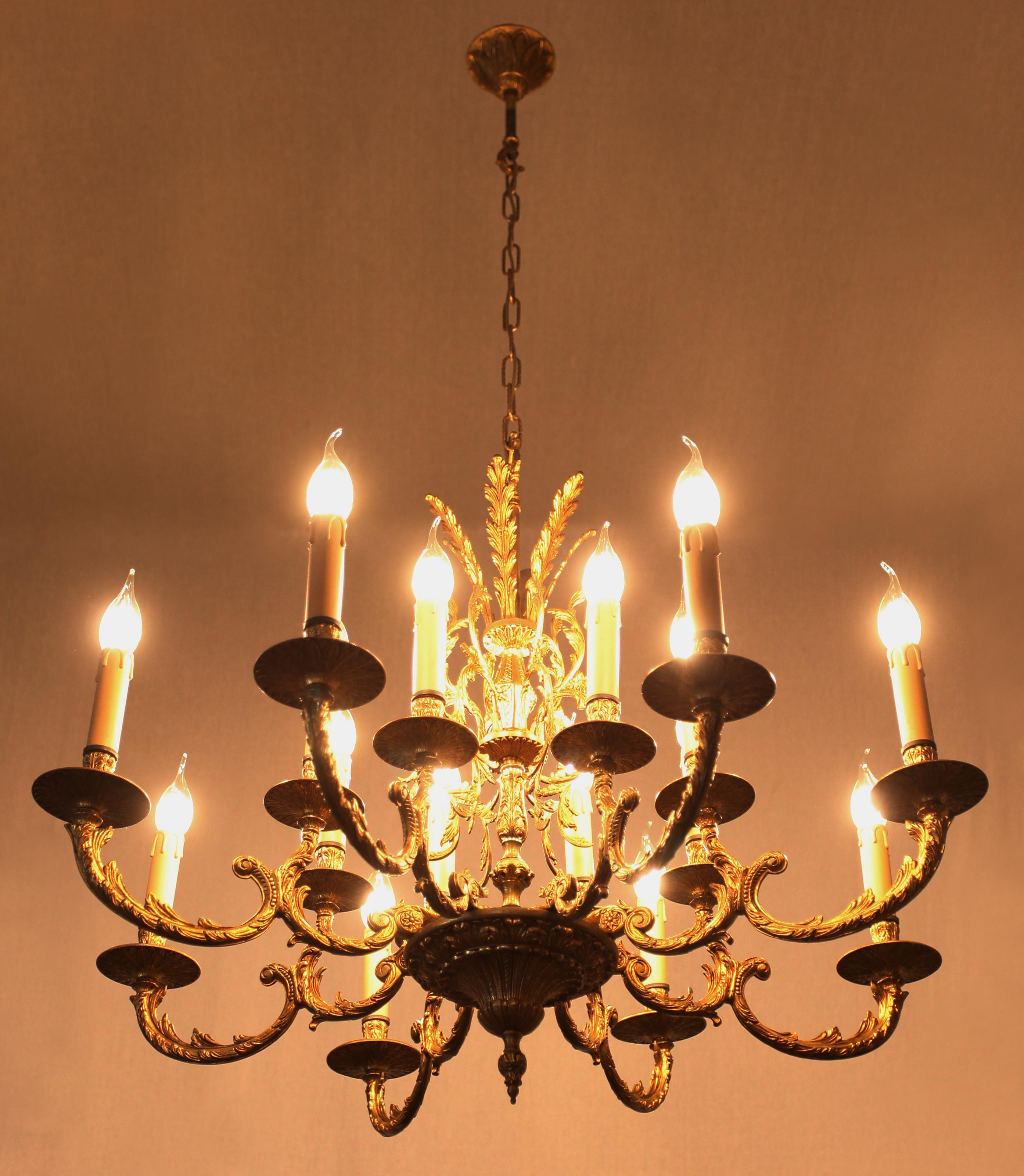 A richly decorated chandelier made of polished brass in the Rococo style. The chandelier has a completely restored electrical installation in copper (new wiring, sockets and sockets) - ready for use. The chandelier is for classic candle bulbs with