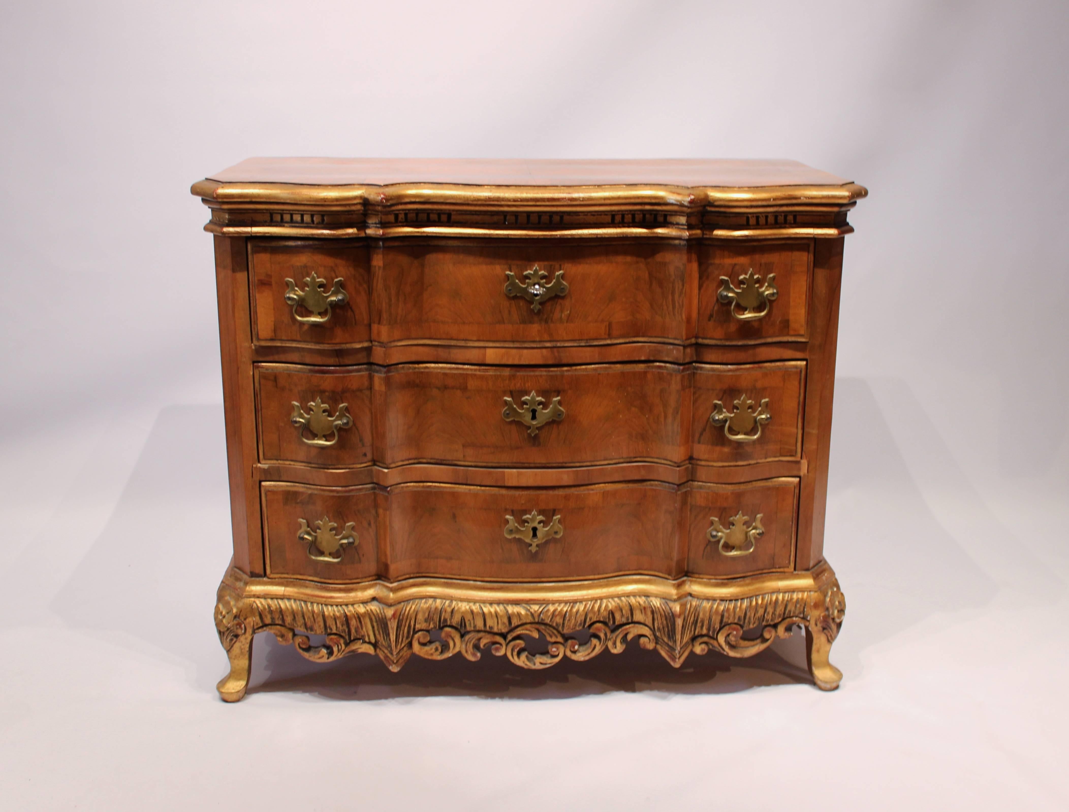 Rococo chest of drawers in walnut decorated with gold leaf from Denmark from the 1880s. The chest is in great vintage condition.