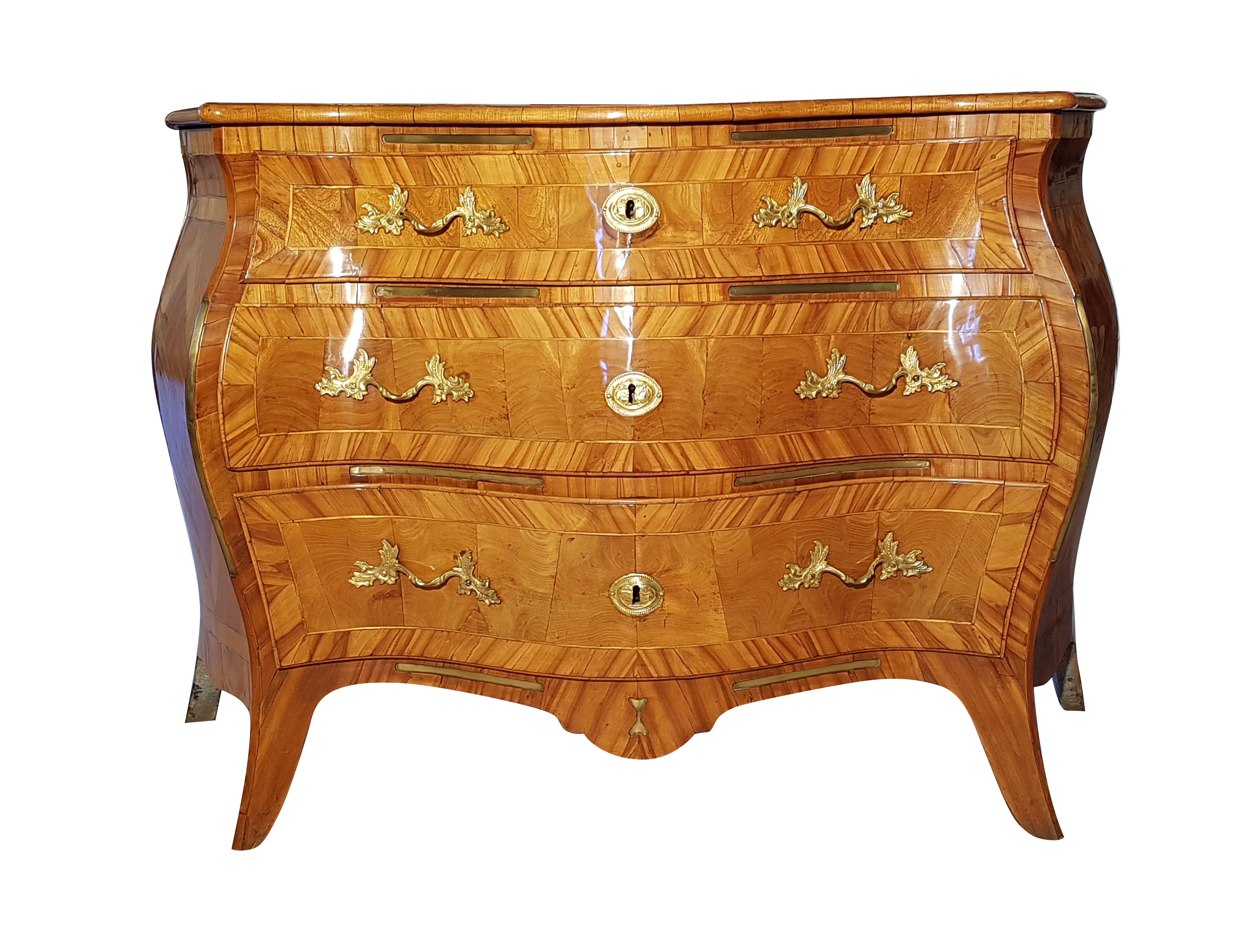 This magnificent commode from the Rococo period was carefully restored - preserving the patina - and polished by hand with shellac. Various fruitwoods make up the wonderful veneer of the curved piece and create a bright variety of colors and