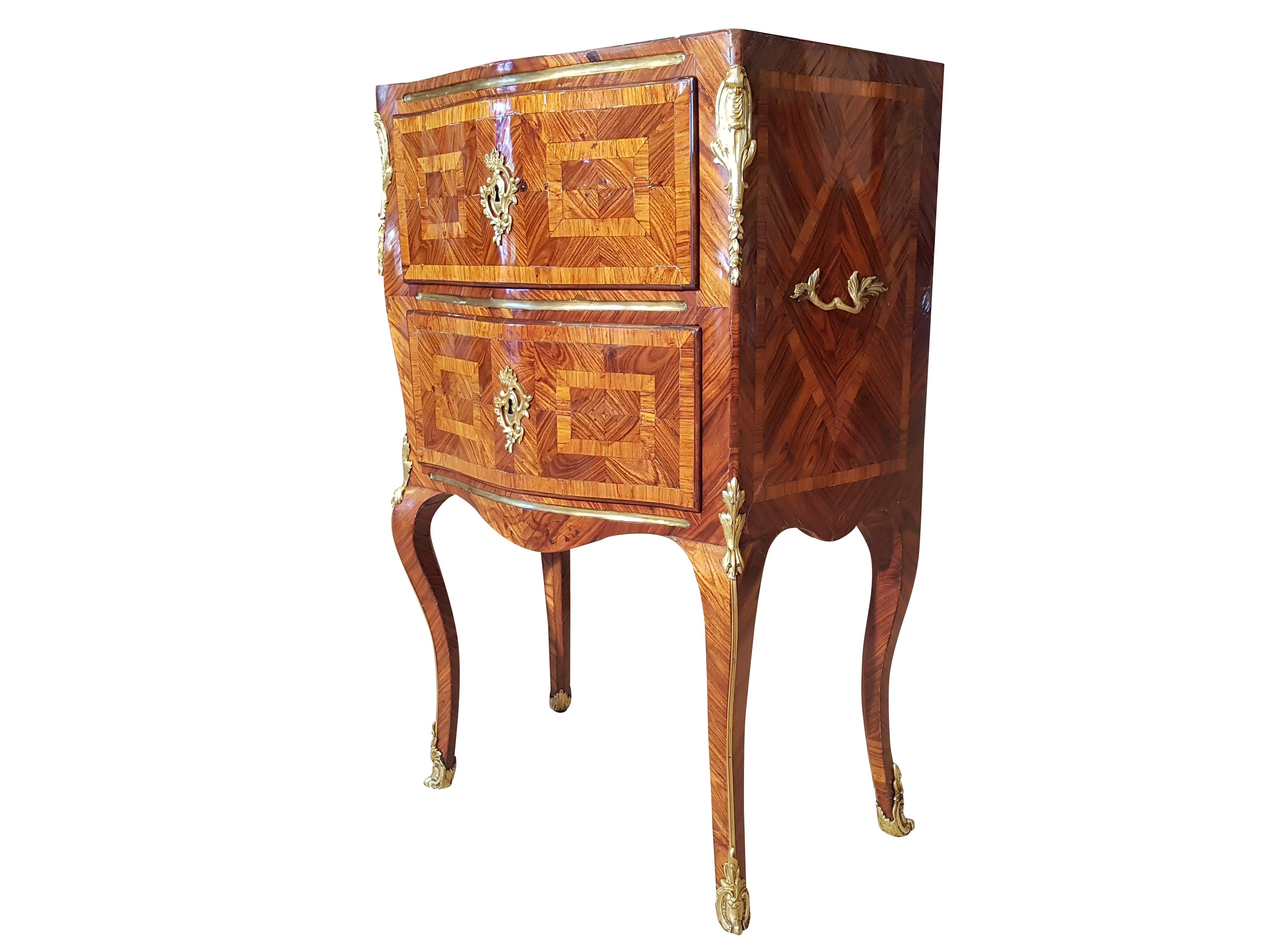 Rare, petite French commode from the late Rococo period. Original piece build, circa 1800, comes with a restoration booklet and “Certificate of Authenticity”. Features a stunning palisander veneer and fire gilded fittings. Got restored while