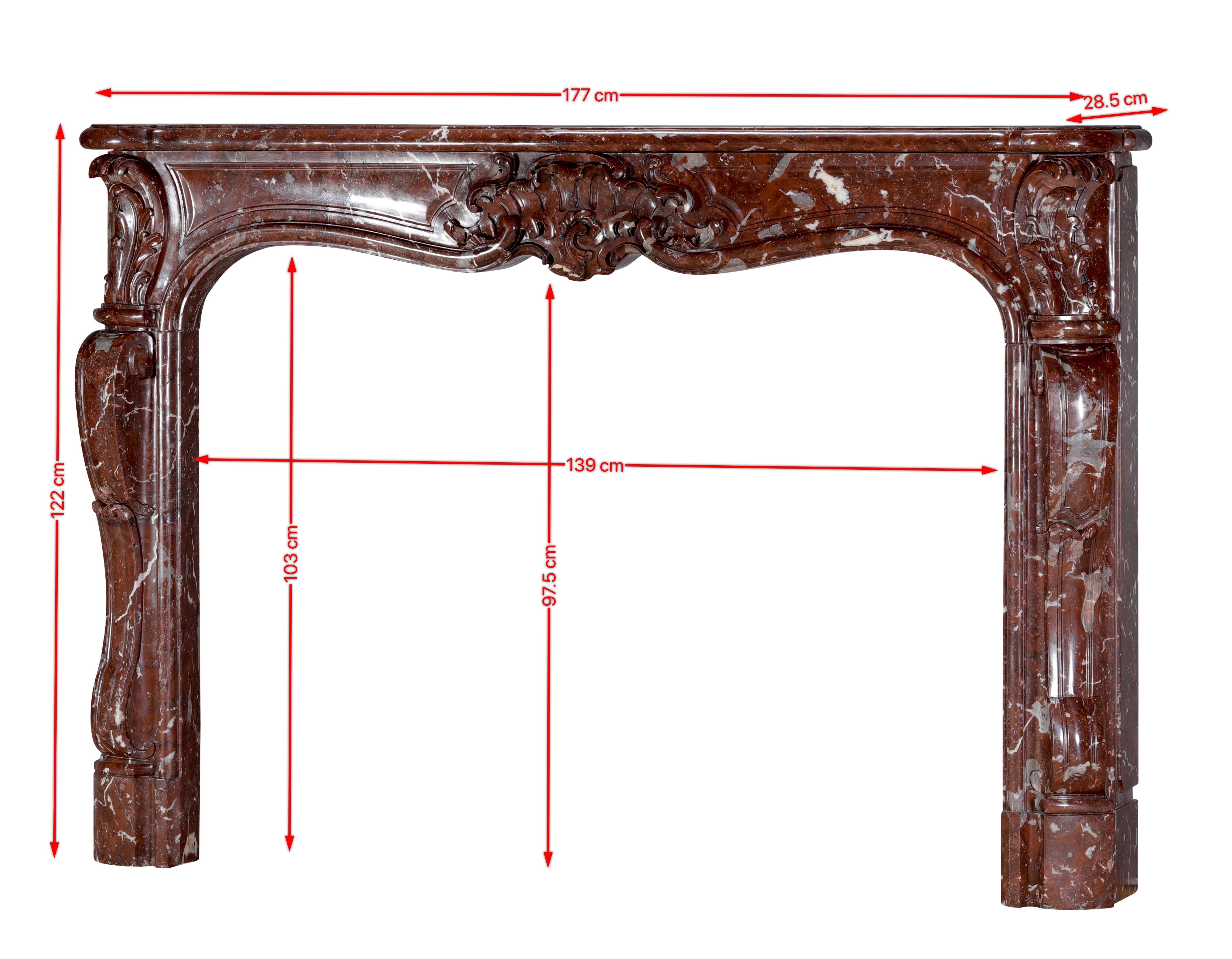 This authentic 18th-century Rococo-Regency fireplace mantel is a superb example of Palladian-influenced French craftsmanship, sculpted in rare Royal Brown Belgian marble. Its deep chestnut tones, veined with delicate white streaks, reveal both