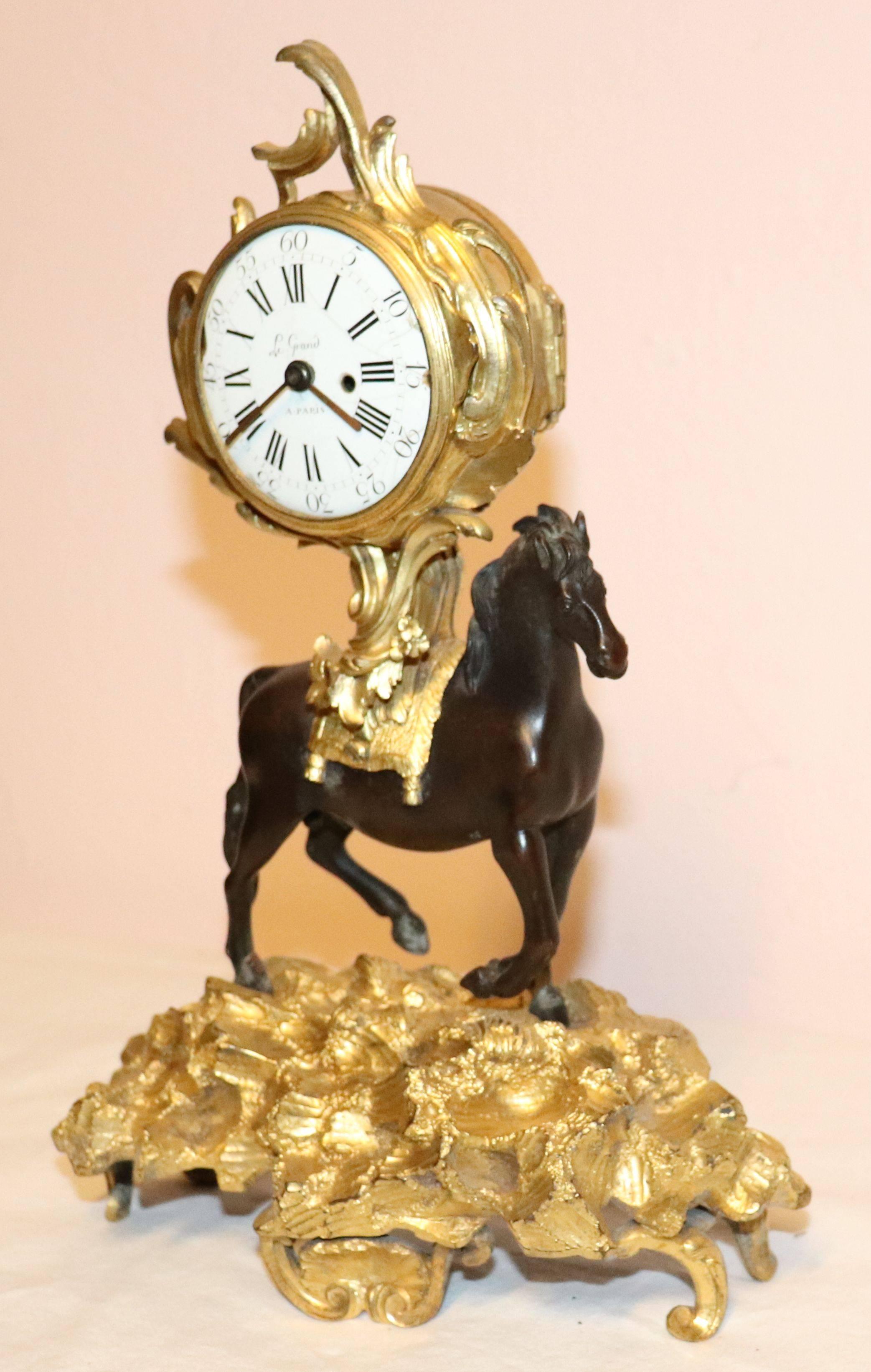 Rococo gilt bronze clock with a patinated horse.