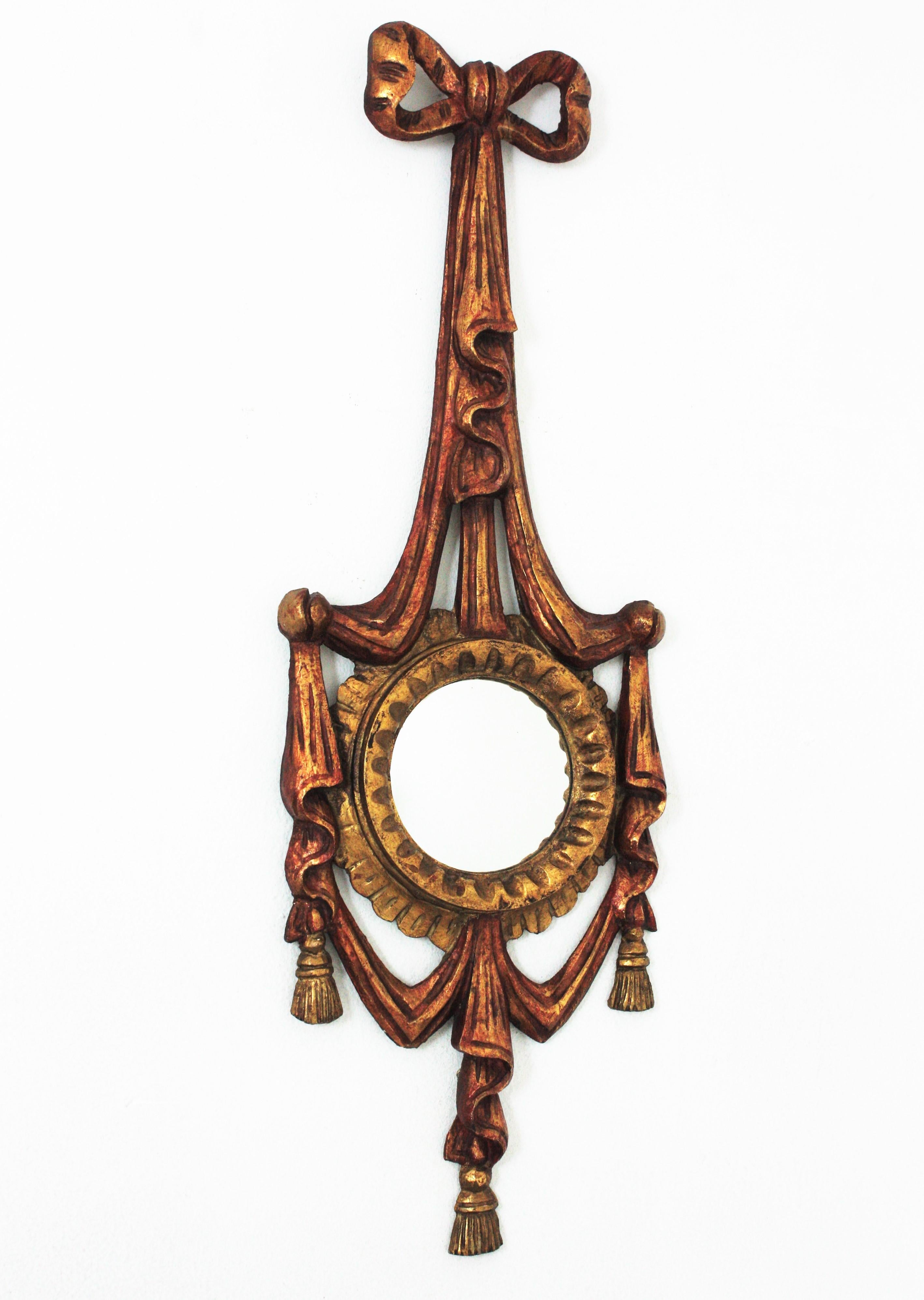 Miroir unique en son genre en bois doré sculpté avec des détails de rubans et un fronton en arc. Italie, années 1940
Ce miroir mural étonnant a un verre convexe et est joliment décoré d'un cadre à nœuds et rubans dans des tons polychromes rougeâtres