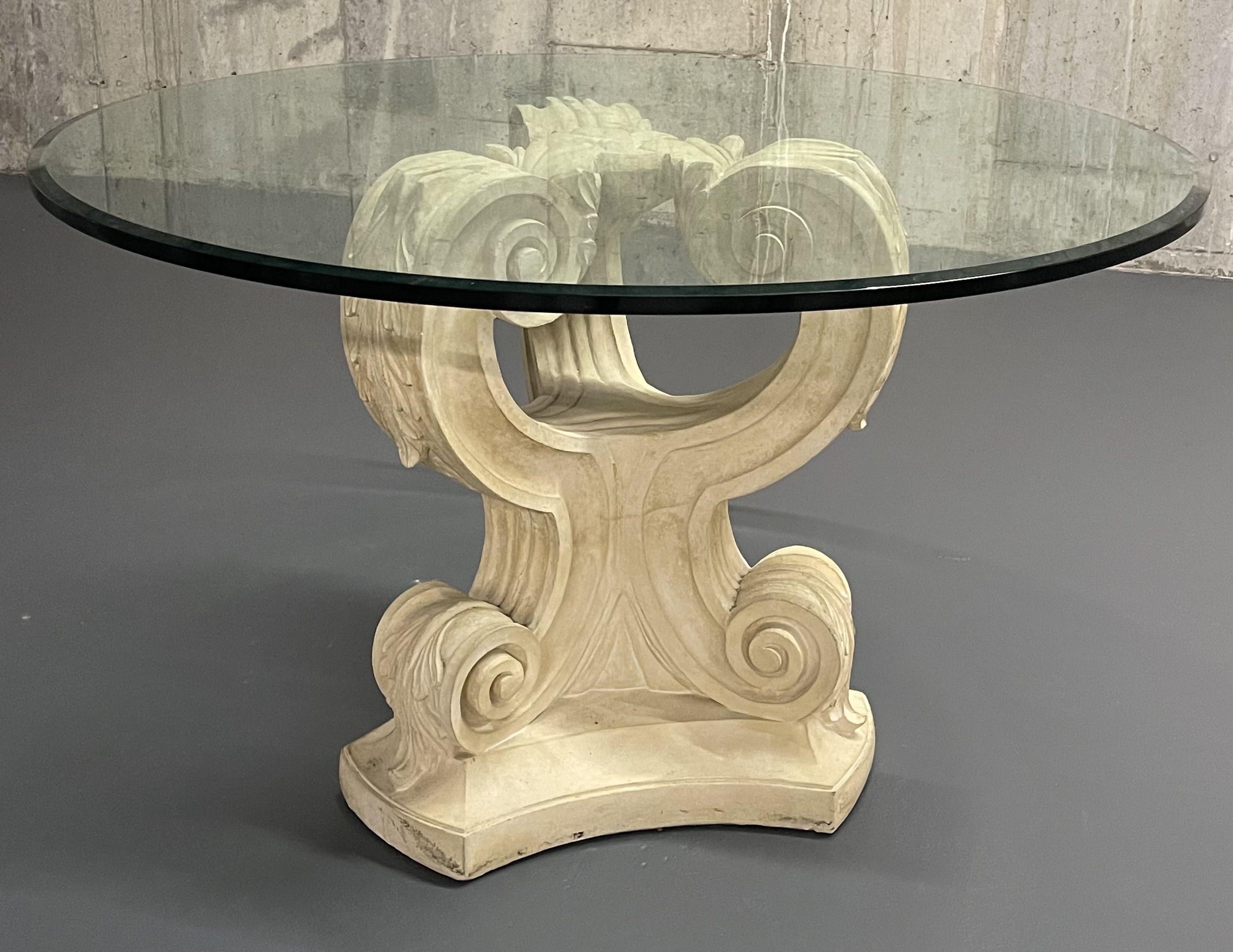 A Rococo table base of leaf and scroll design having a thick beveled glass table top. Sleek and stylish. Base measures 24 inches in diameter and 29 high.