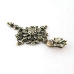 ROCOCO Gold and silver pendant in the shape of a cross set with rose-cut diamond