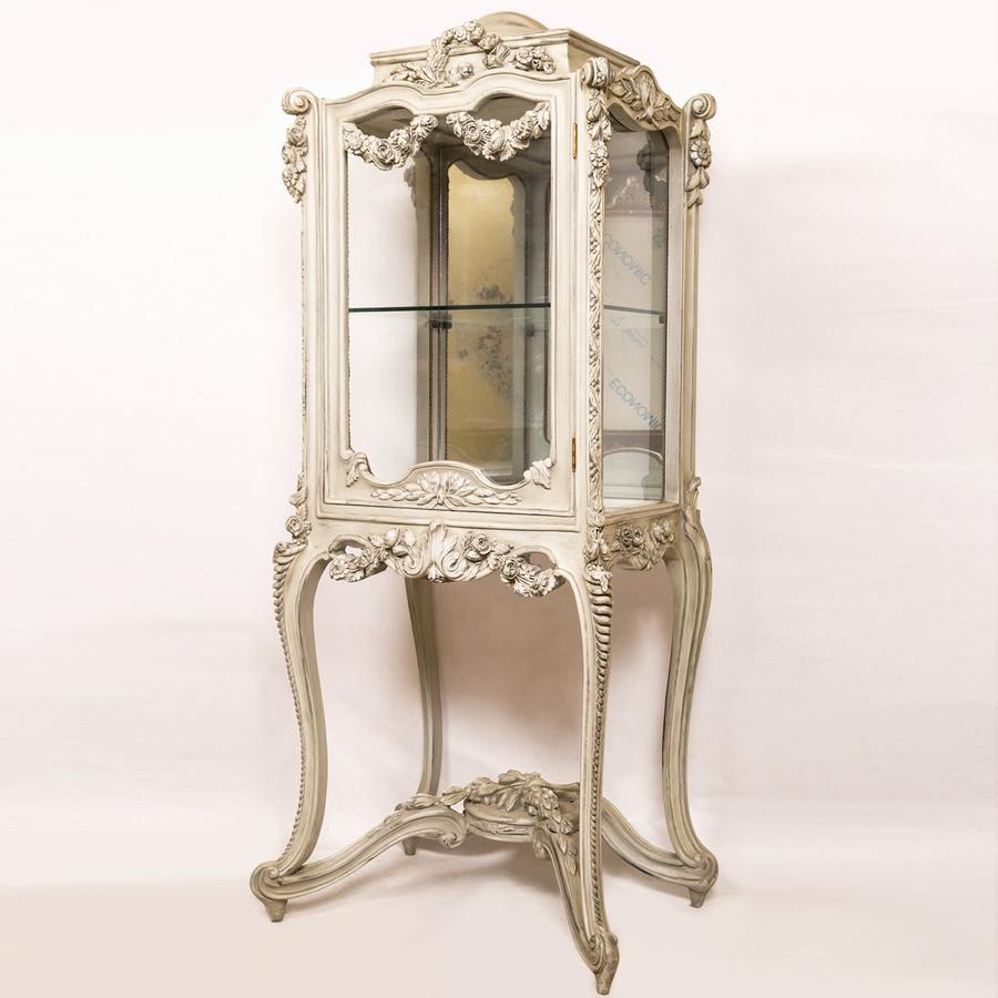 A superb Rococo hand carved French vitrine, 20th century. 

The Rococo hand carved French vitrine was inspired by the late 19th century French furniture. This style is known by its elegant asymmetrical forms and floral ornament. This beautiful