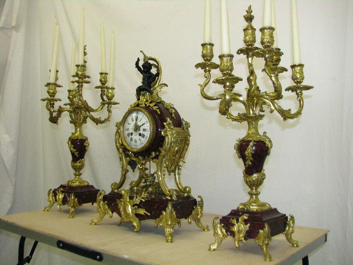 Rococo mantel clock with two candelabra cherry marble gilded bronze, circa 1880
Museum class, palace mantel clock with two candelabra.
A prestigious rococo set (the so-called suit) was created circa 1880,
probably on individual order.

Clock