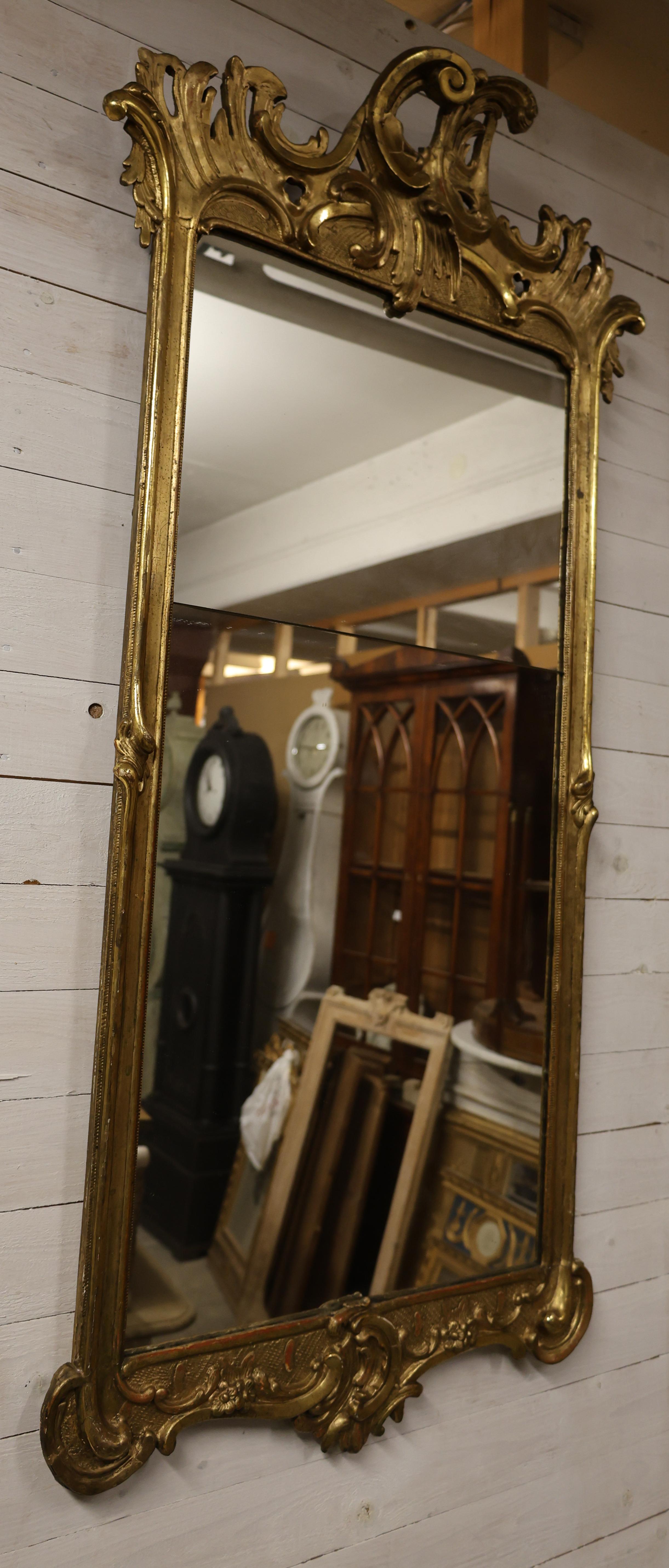 The mirror is from Northern Germany or Denmark. It was made during the Rococo period. The mirror is gilded in various colors.
