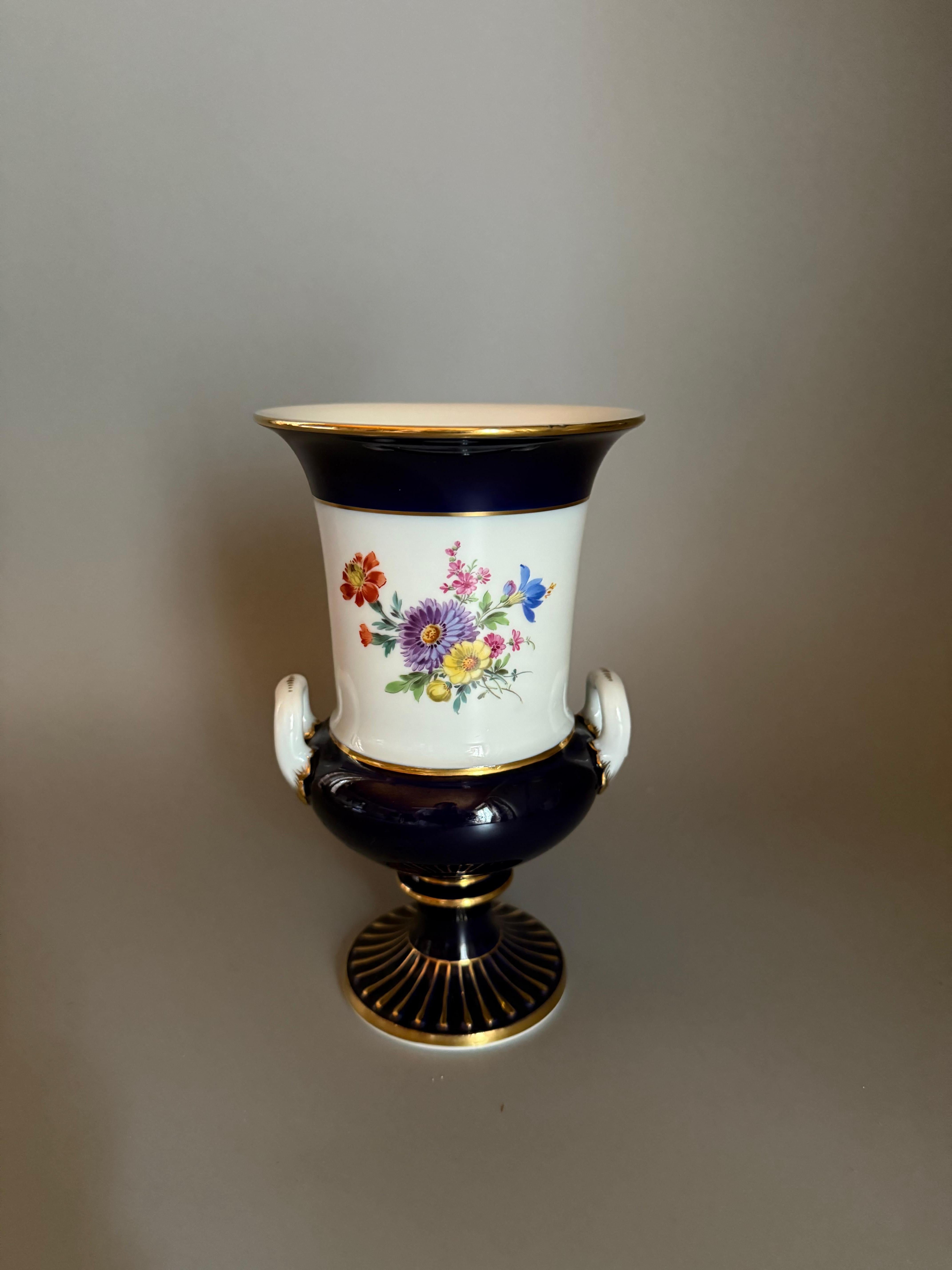 Indulge in the timeless allure of the “Cobalt Elegance” Meissen Porcelain Floral Vase with Gold Accents.


This exquisite masterpiece seamlessly marries the richness of cobalt blue with delicate floral patterns, creating a captivating dance of