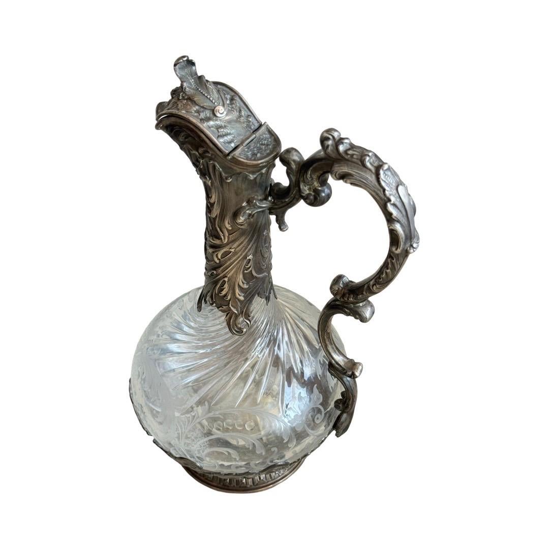 An exceptional 19th century French claret jug crafted from finely hand-engraved crystal and mounted in high-quality sterling silver (.950), bearing the Minerva hallmark.

Executed in the elegant Rococo Revival style, this piece features ornate