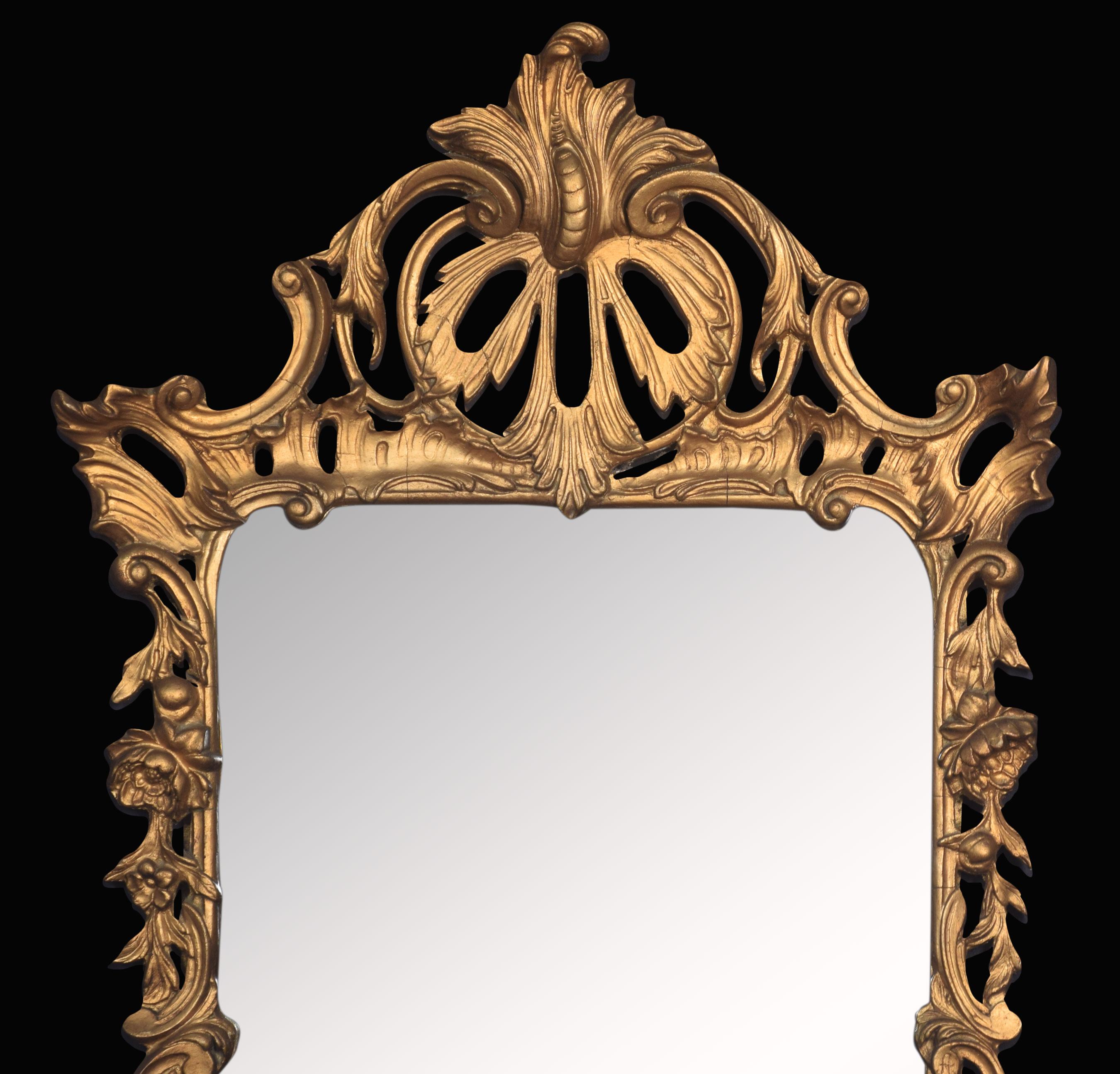 Rococo Revival gilt wall mirror. The original rectangular mirror plate surrounded by giltwood C scroll acanthus and floral frame.
Dimensions:
Height 34.5 inches
Width 19.5 inches
Depth 2.5 inches.