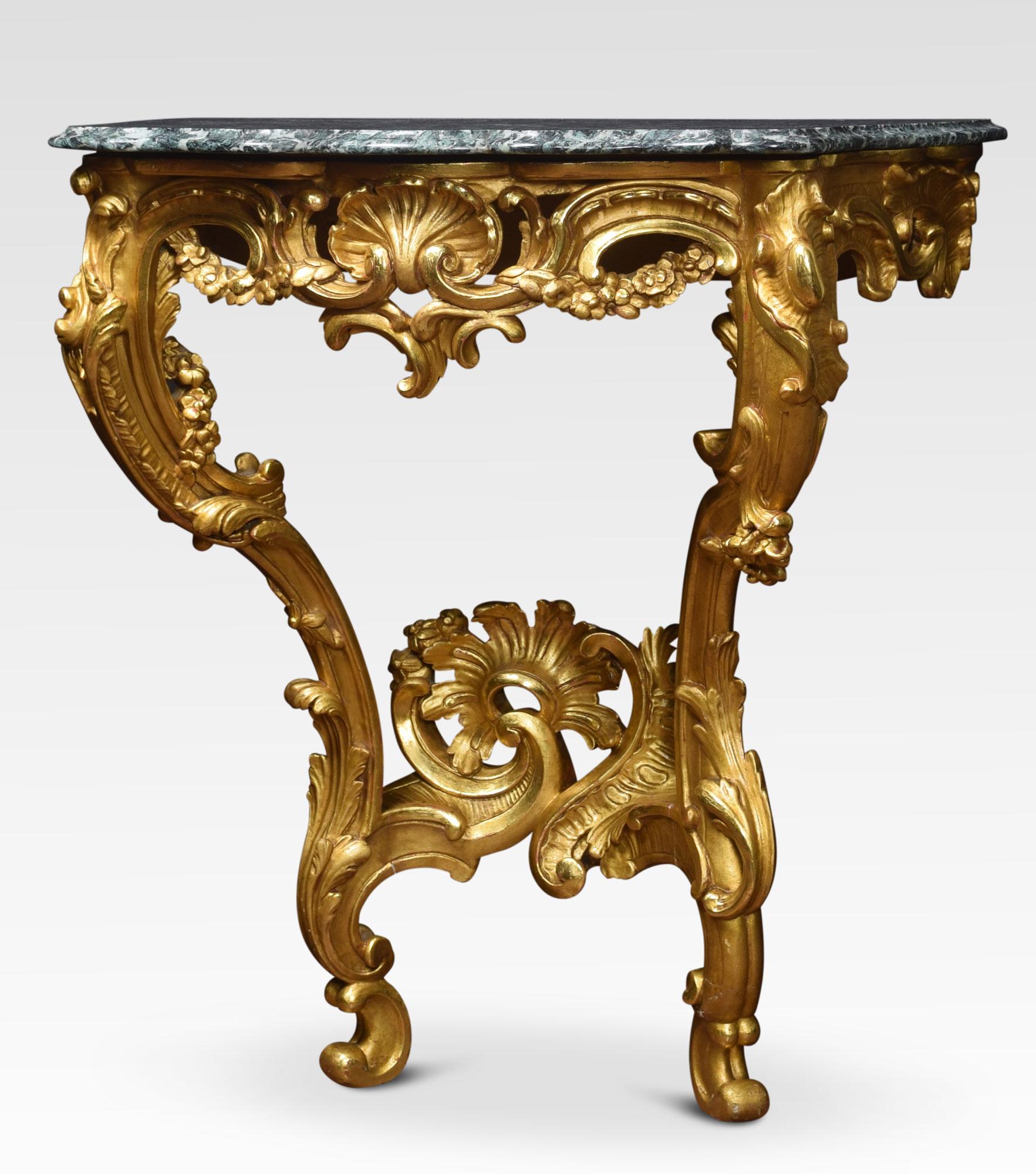 Rococo revival giltwood and marble console table. The serpentine green marble top over a foliate, shell and floral swagged base with two cabriole style supports. United by a pierced foliate stretcher, all raised up on scrolling