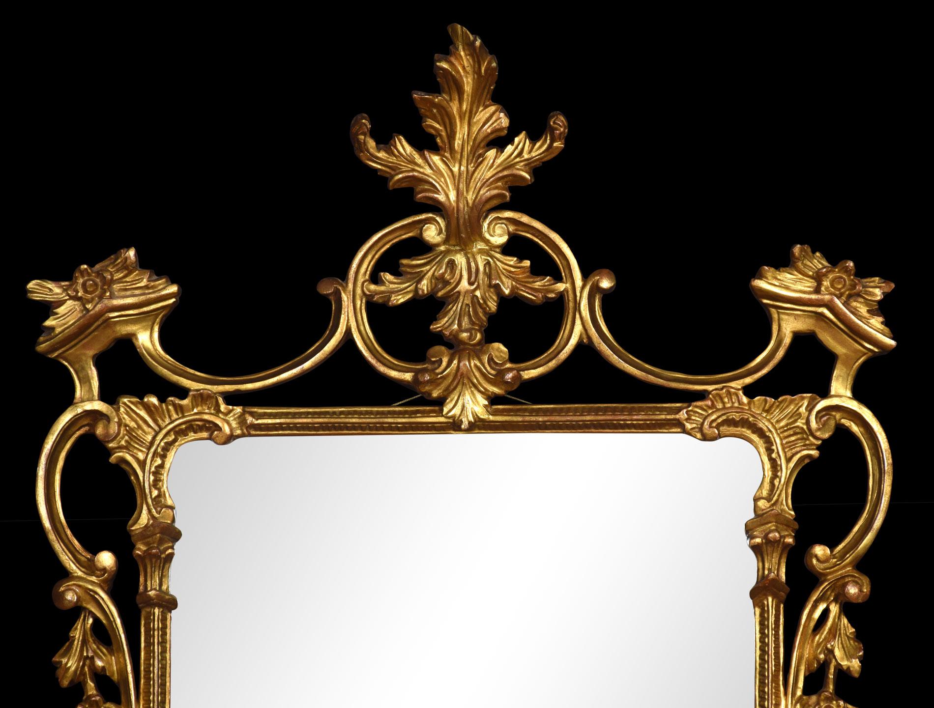 George III style Rococo Revival giltwood mirror. The original cartouche-shaped bevelled plate mirror within a conforming frame elaborately carved with rocaille and c-scrolls.
Dimensions
Height 50 Inches
Width 28.5 Inches
Depth 4.5 Inches