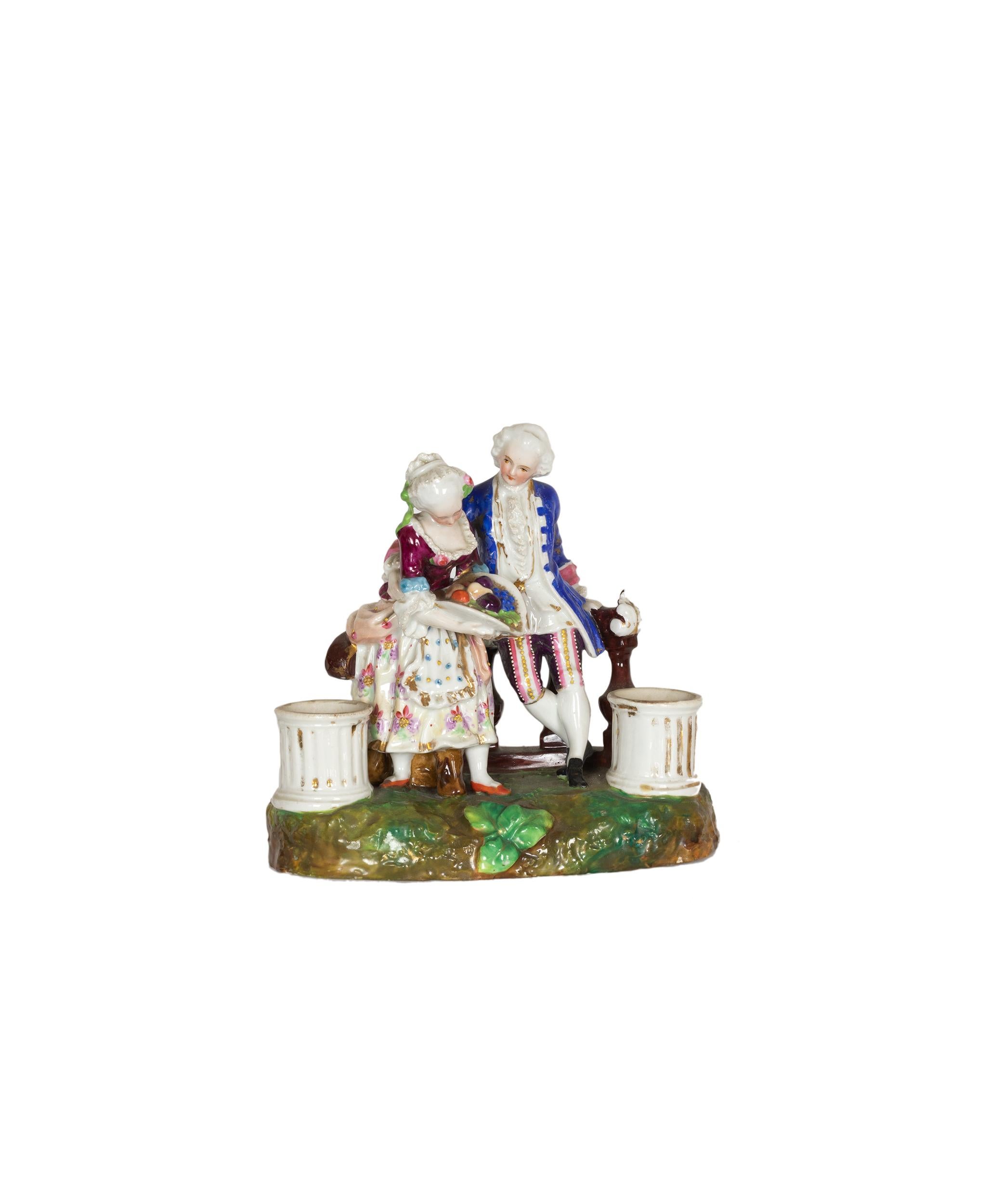 A graceful porcelain inkwell station, crafted from Meissen porcelain, features two inkwell compartments. The piece exhibits excellent condition, consistent with its age and boasts a stunning color palette. The bottom of the inkwell bears the