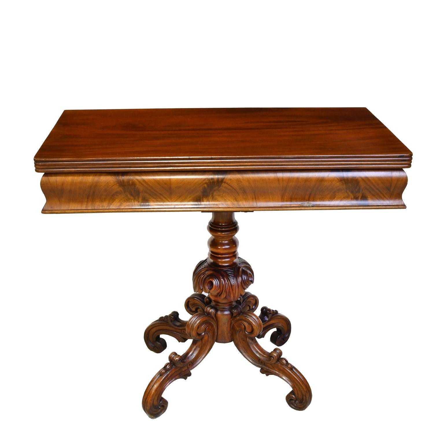 Une très belle table de jeu de style rococo en acajou. Le plateau rectangulaire repose sur un socle en acajou massif avec un poteau d'acanthe tourné et sculpté qui se termine par quatre pieds à volutes en 