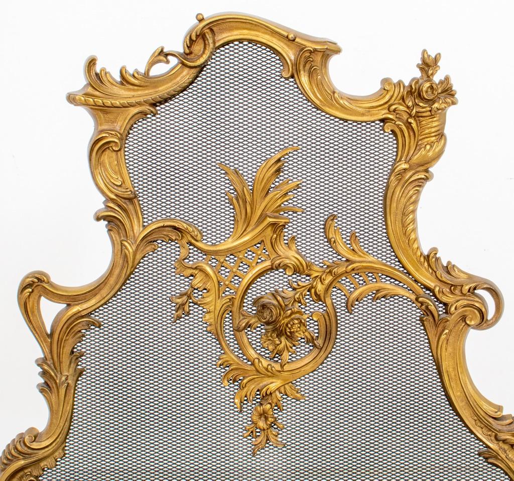 Rococo Revival manner gilt brass and mesh fire screen of scrolling floral design.

Dealer: S138XX