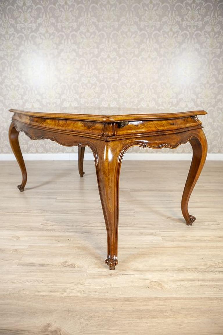 Rococo Revival Walnut Center Table From the Early 20th Century

The table with a rectangular top and a profiled wavy edge is supported on bent legs.
What really draws attention is the top veneered with incredible walnut burl.
The table cannot be