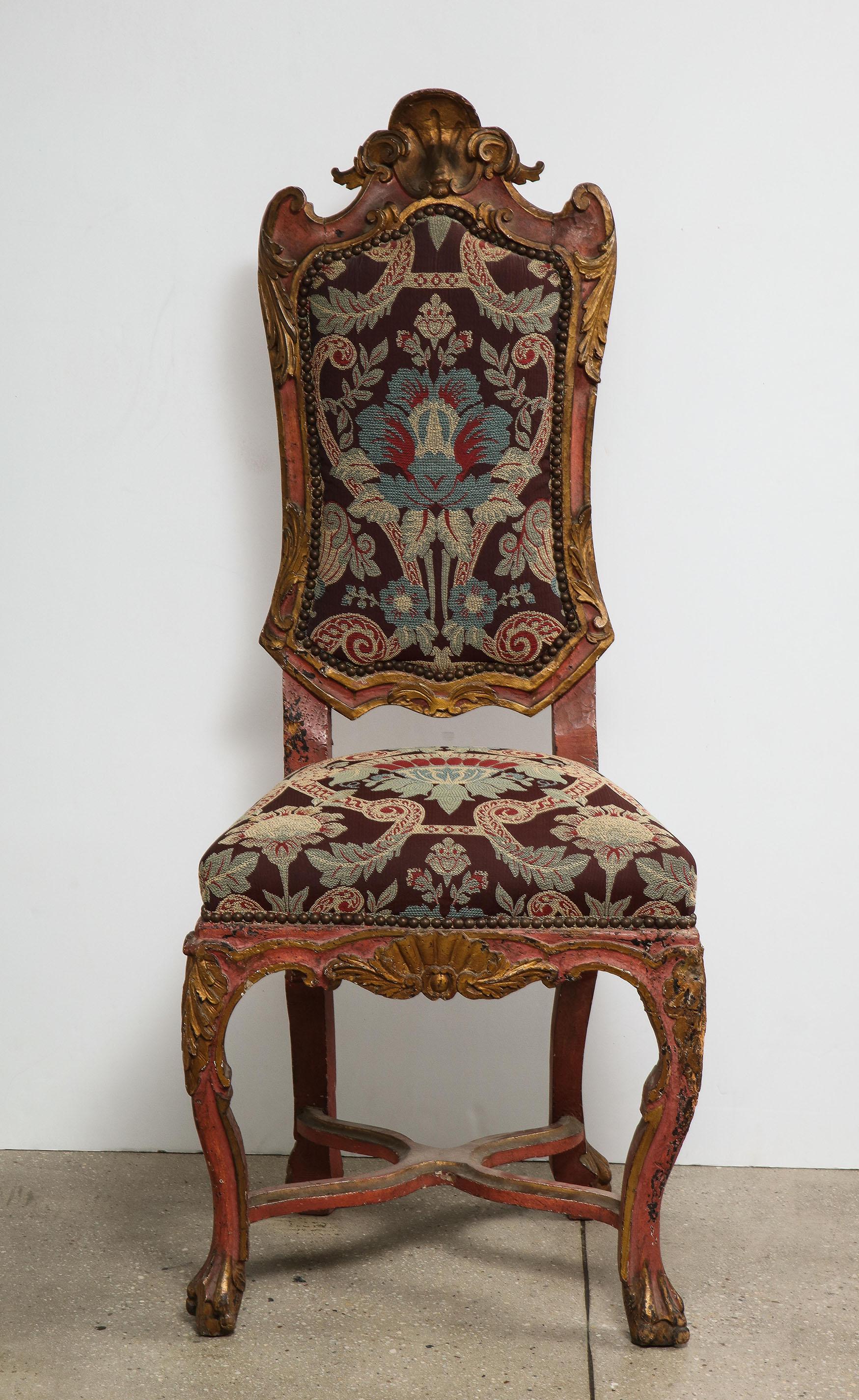 Italian painted and gilt Rococo chair

The painted and gilt all over intricately carved Rococo chair, with an inset upholstered back and seat, four cabriole legs with an X-form stretcher.