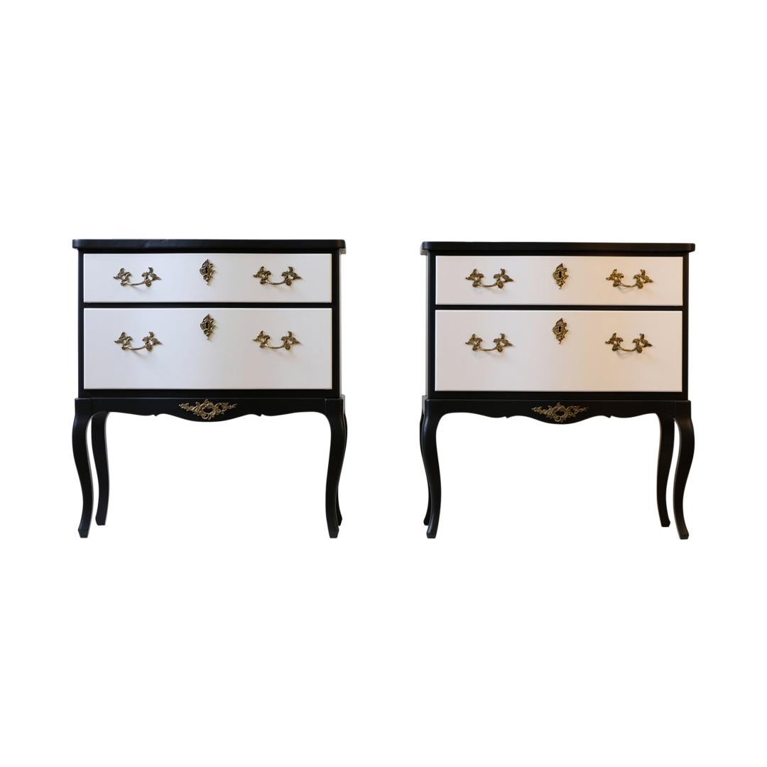 A pair of antique Rococo commodes renovated to the highest standard and custom painted to provide a modern interpretation. Matte black with white drawers. 
Width: 62cm / 24.4