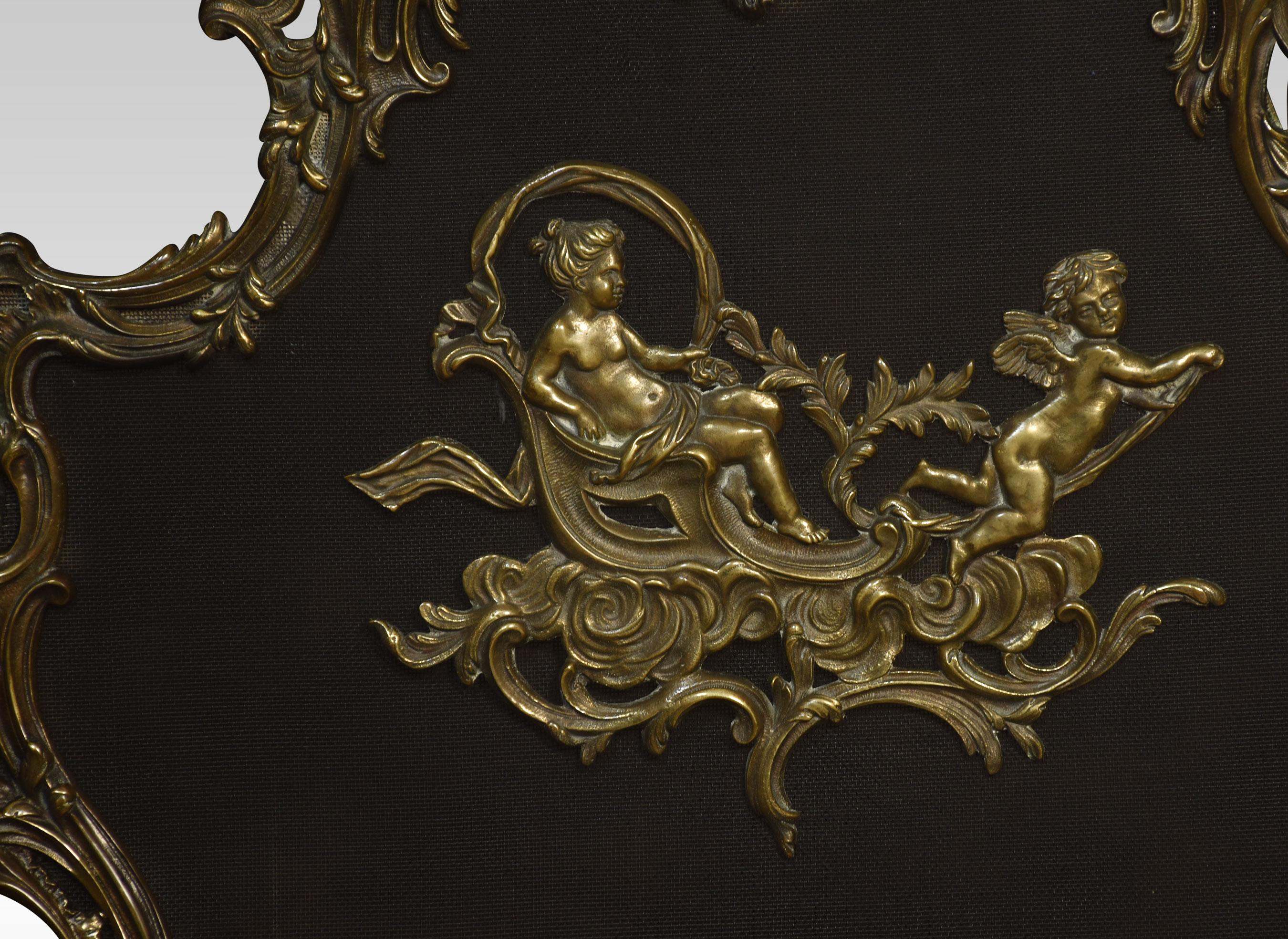 Brass and mesh fire screen. The Rococo style frame is composed of detailed scrolls and vines, and the mesh panel center with a playful gilt bronze putti appliqué. The frame rest on four carefully executed scrolled legs.
Dimensions
Height 31.5