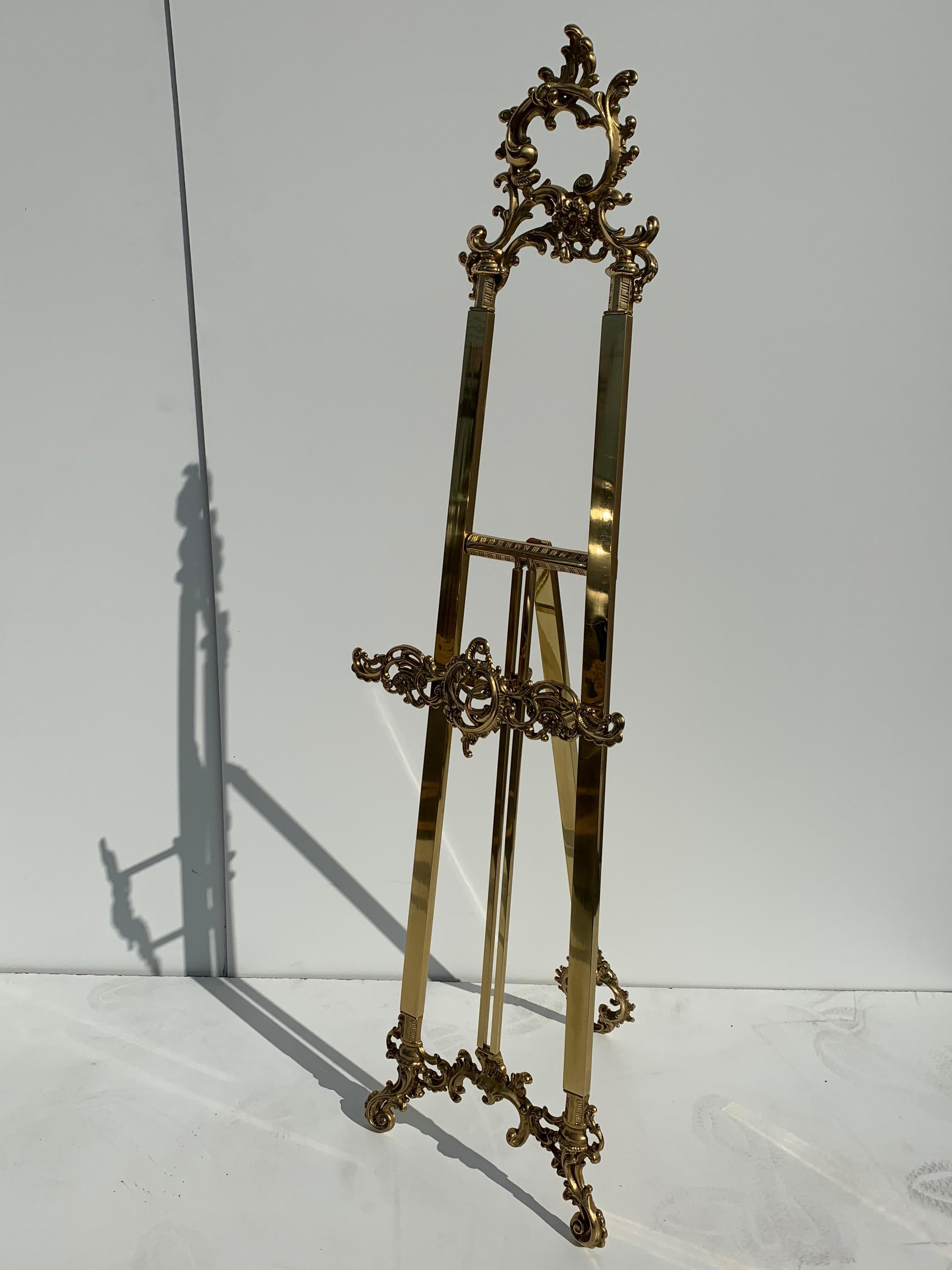Small Rococo style brass adjustable floor easel. Last photos shown are with our large easel for size comparison.
  