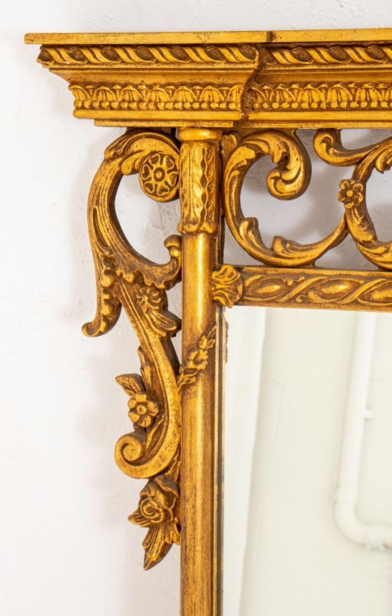 Rococo revival giltwood over mantle mirror heavily decorated with acanthus leaves motifs.