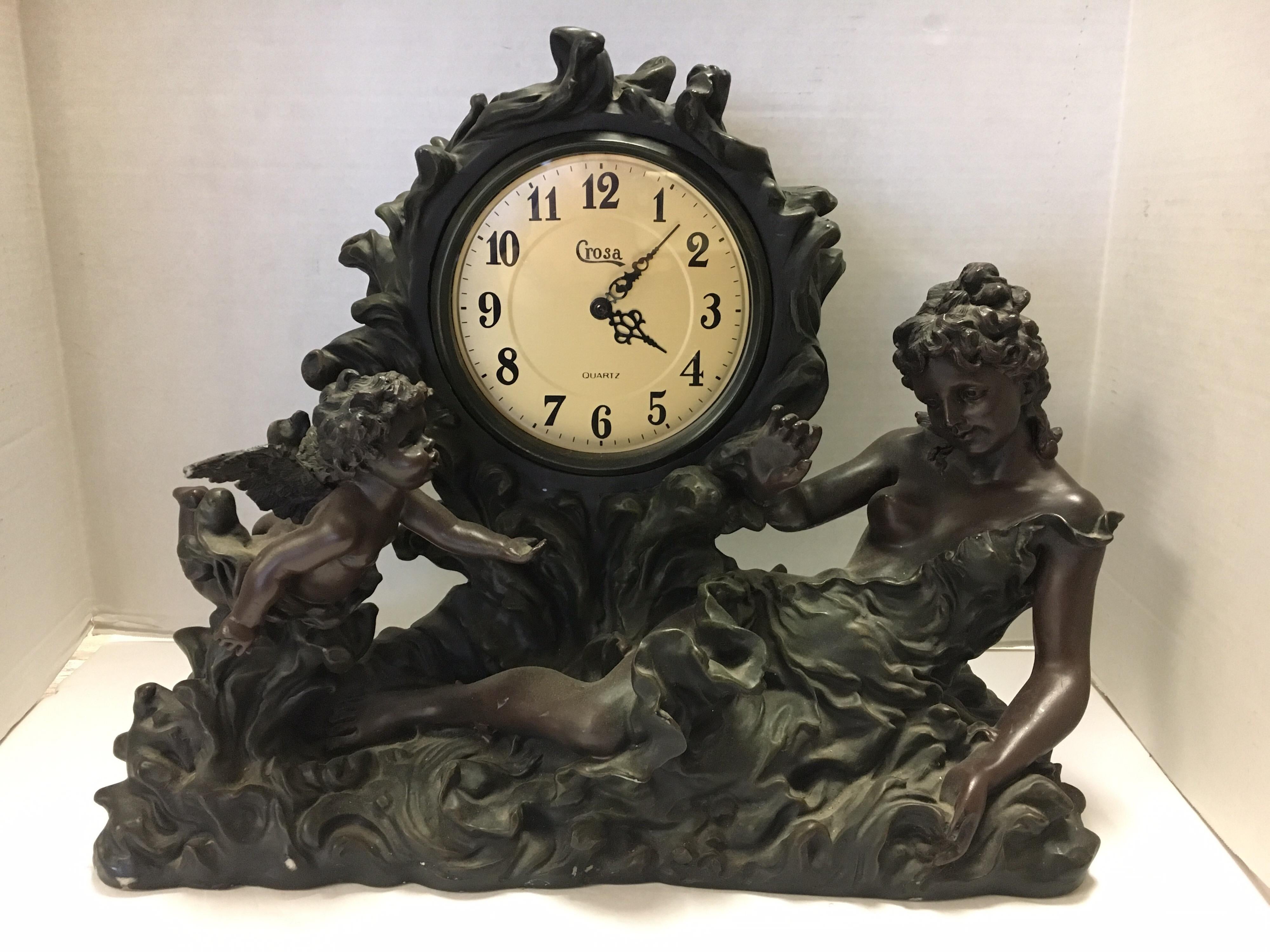 Mid-late 20th century Rococo style intricately carved decorative mantel clock.
Depicts woman and cherub angel on each side of carved clock casing. Clock is battery operated
as this piece is from the mid to late twentieth century. The color is very