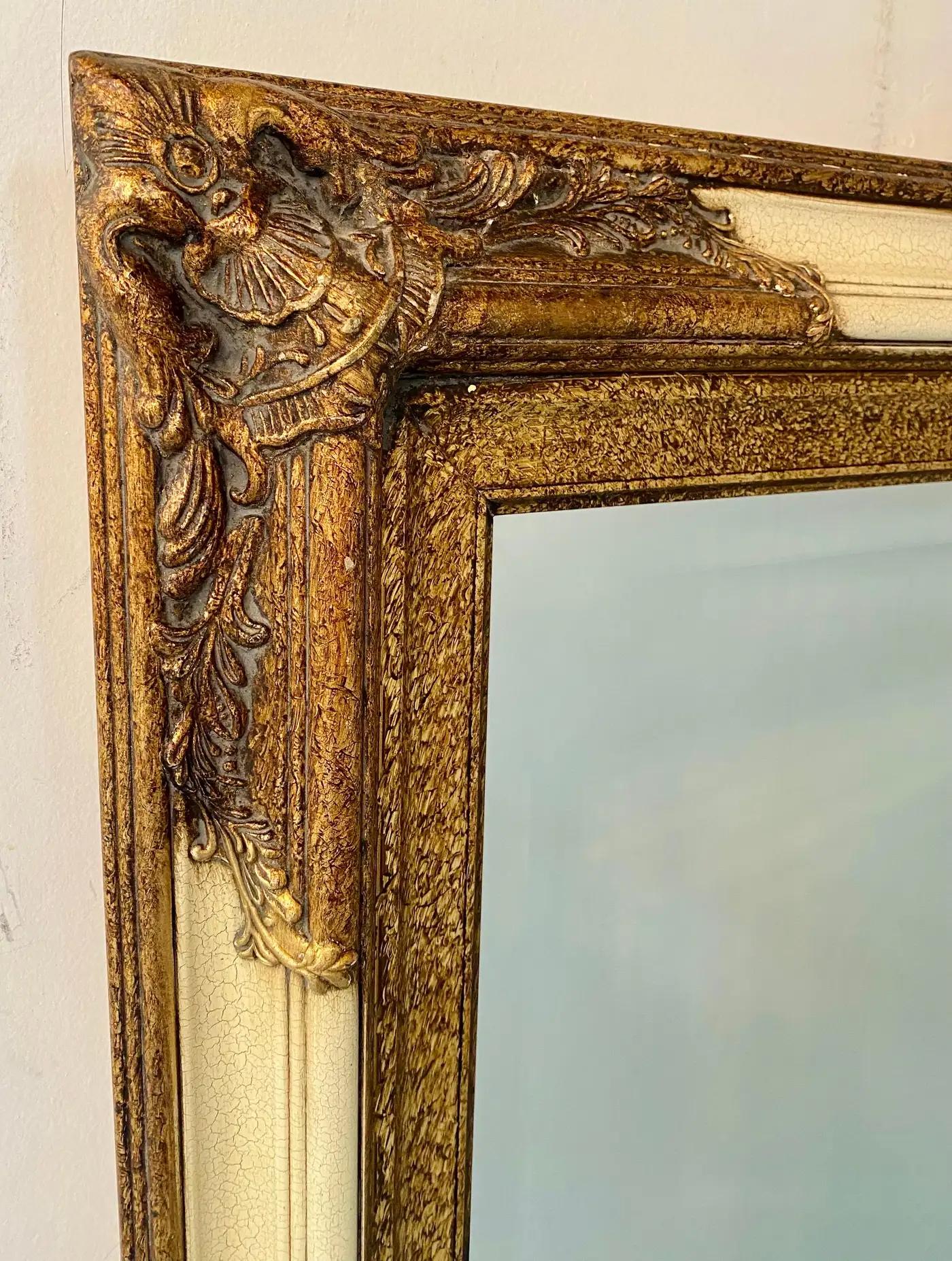 An elegant and timeless quality Rococo style mirror by the Bombay Furniture Co.

The mirror features a distressed look and is fine carving with gilded design as well as beveled glass mirror. The mirror will look great as console mirror, at an entry