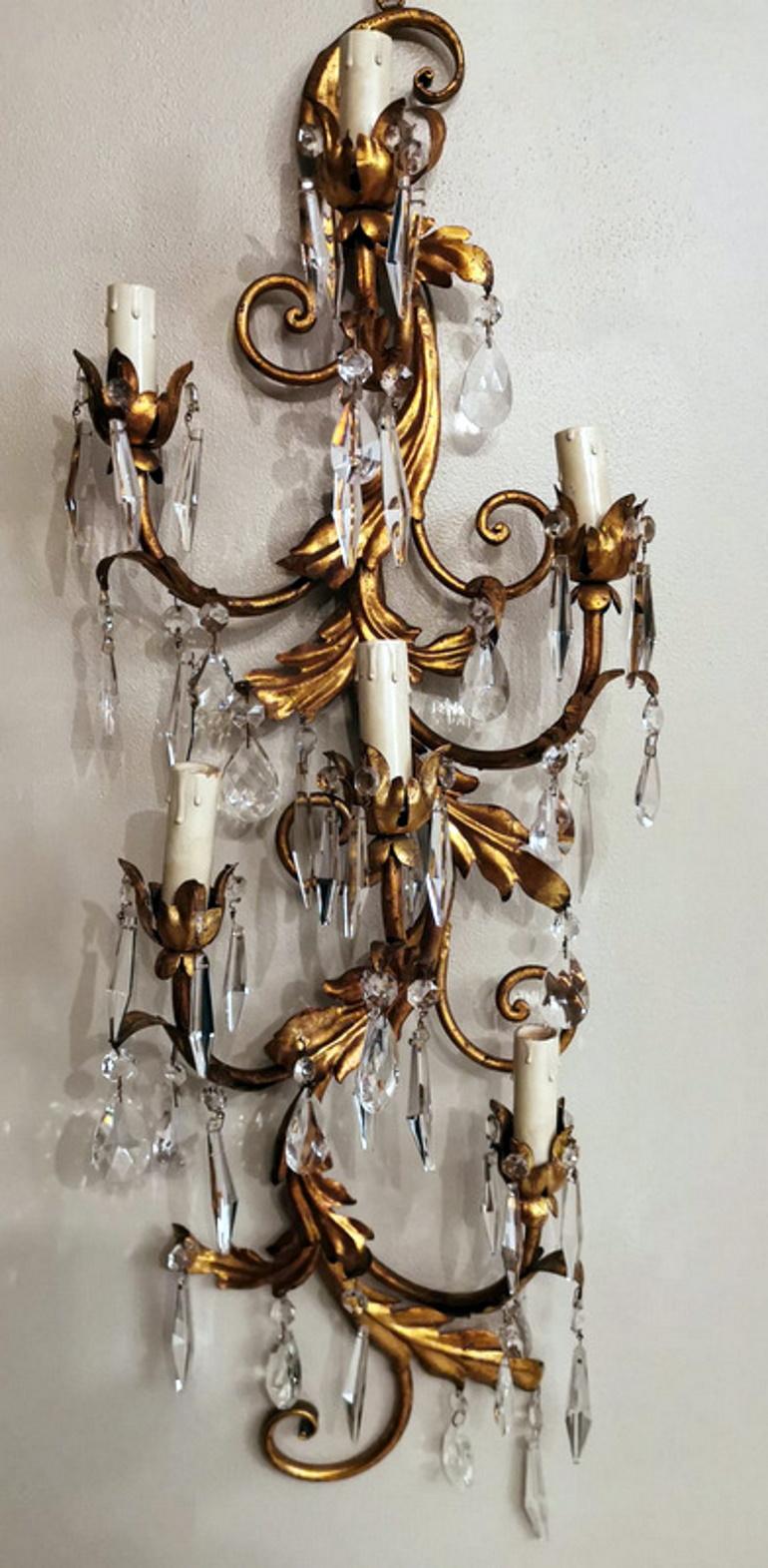 Huge and charming Italian wall sconce; it has six light points with fake candles; the main structure, sturdy and well-proportioned, is made of the solid iron rod and the design follows a precise Rococo style with a soft curvilinear evolution and