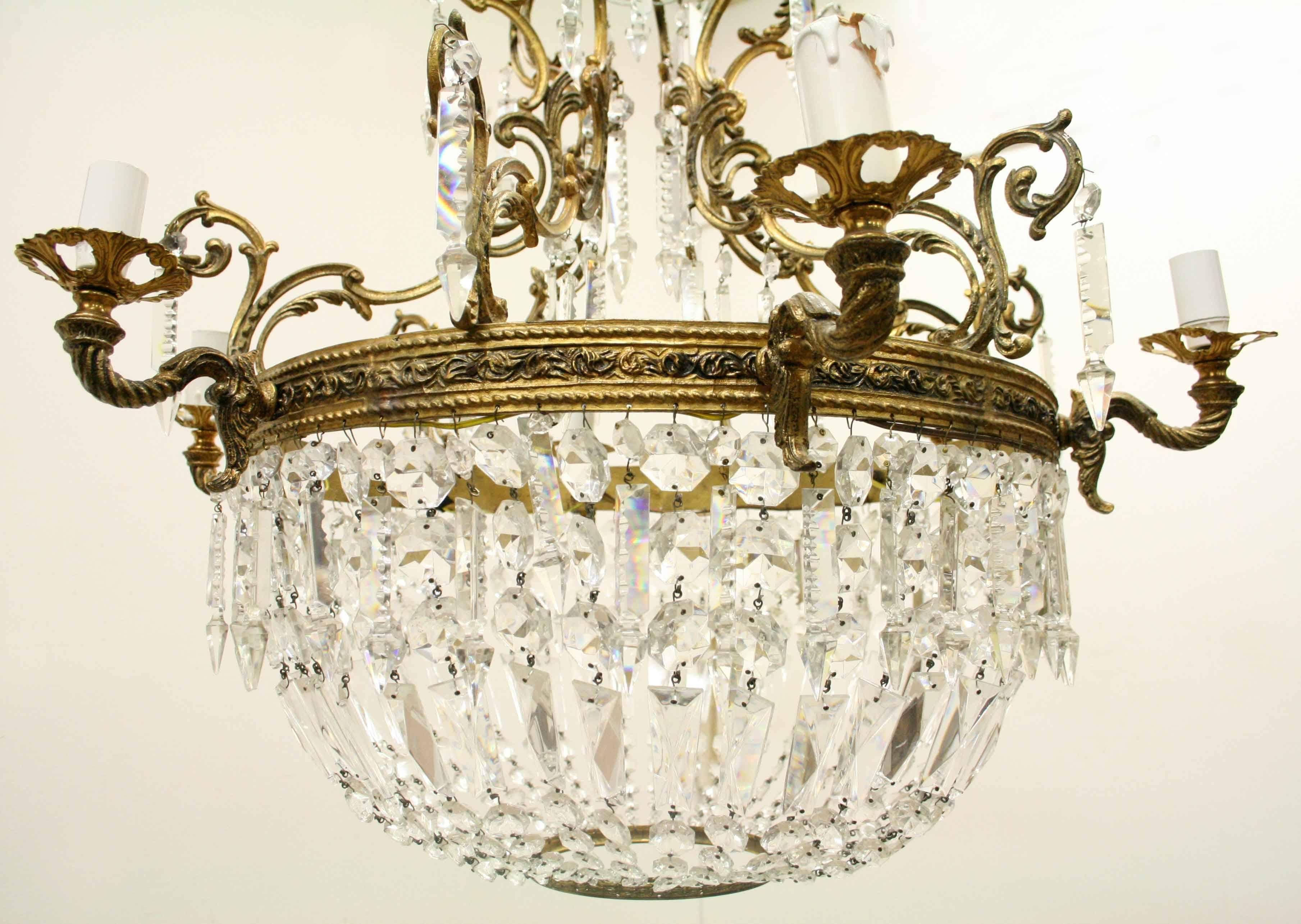 Unusual Rococo style gilded brass and glass chandelier, circa 1900. The top section with its Rococo style brass arms from which the extended glass droplets hang. In the centre is a glass half dome which has a lamp holder in it. Beneath this is a